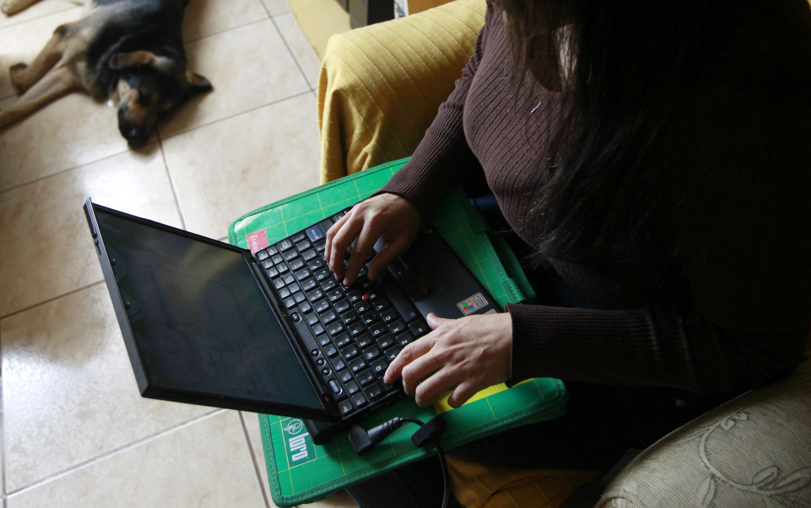 A woman uses her laptop at her home in Lima, September 29, 2011. REUTERS/Mariana Bazo