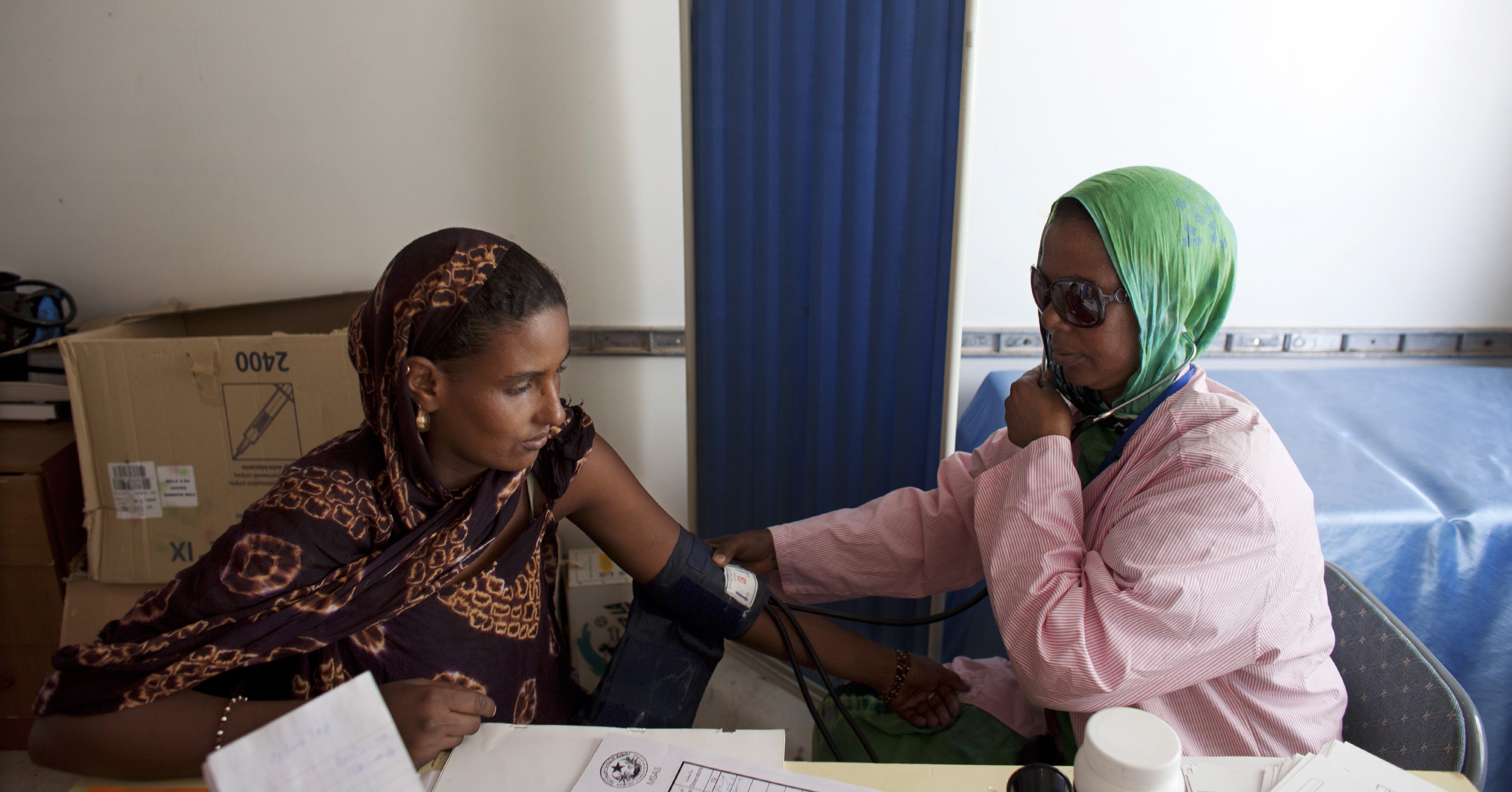 Nurse  takes the blood pressure of Malian refugee at a mobile healthcare center in a refugee camp.  REUTERS/Joe Penney