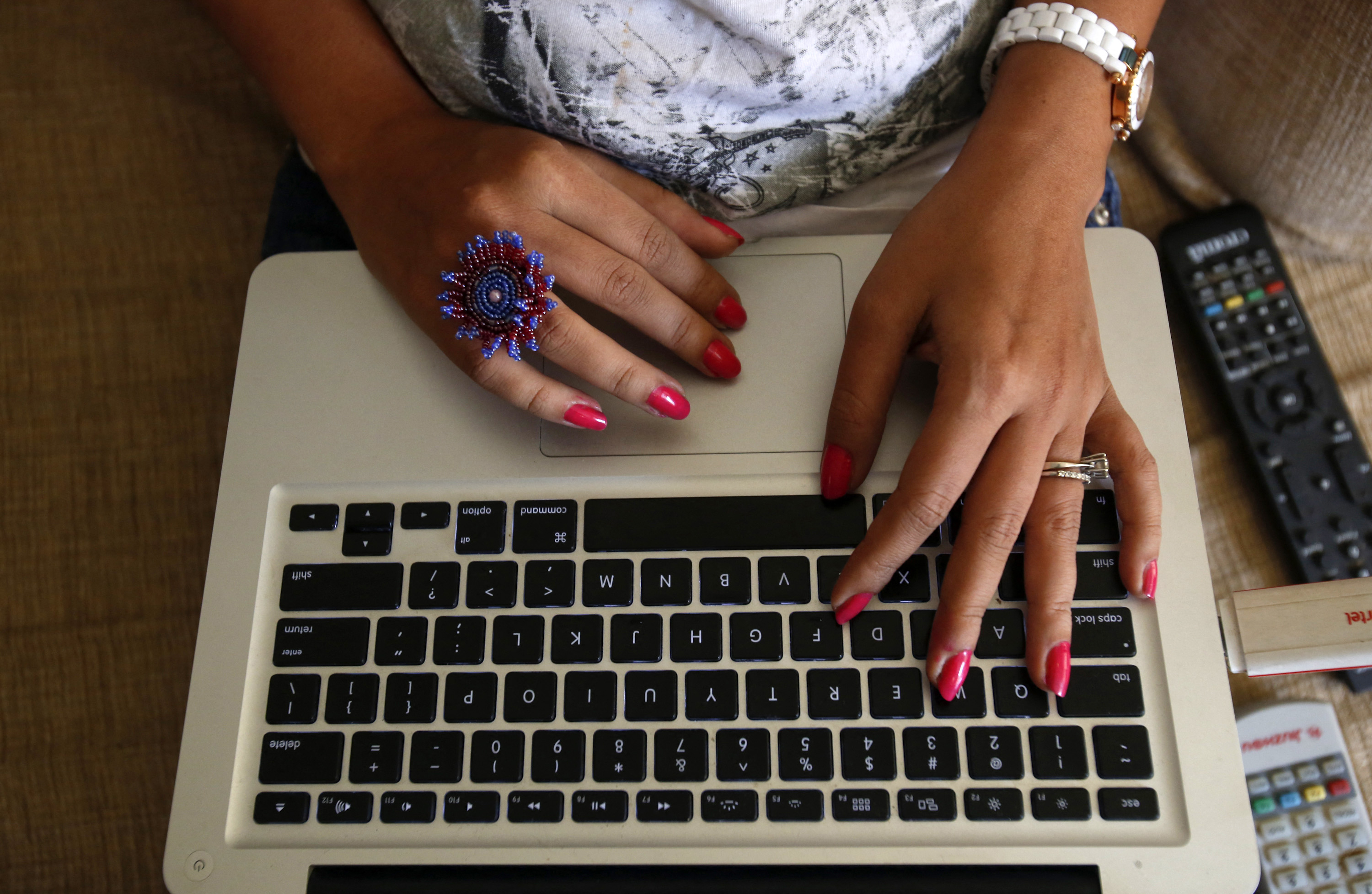 A woman uses a laptop in Mumbai, January 22, 2013. REUTERS/Vivek Prakash