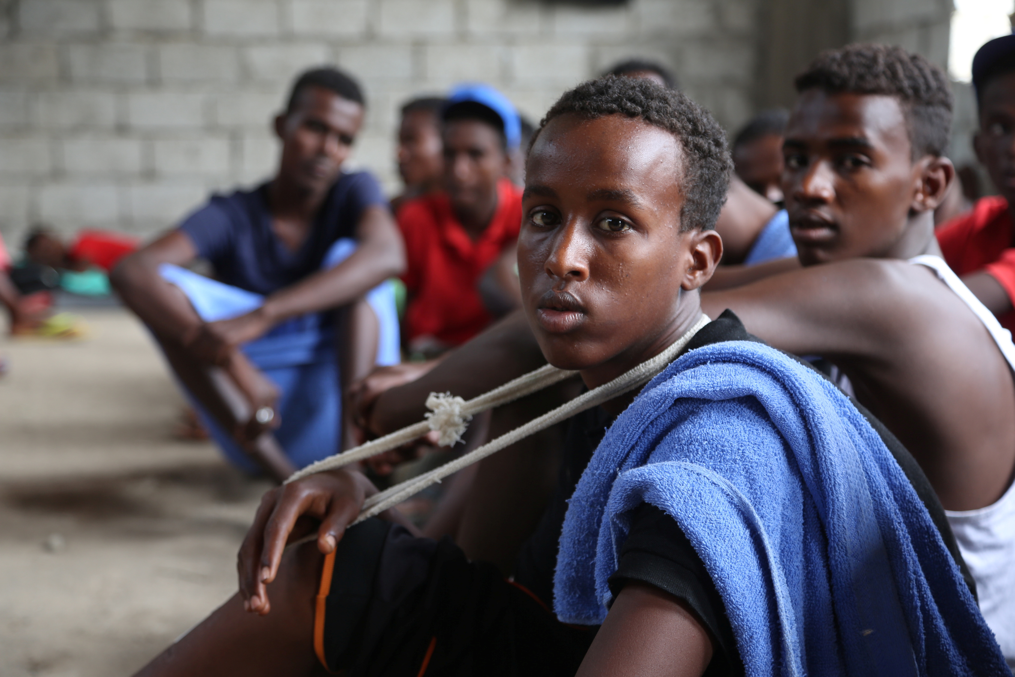 Somali refugees who survived an attack on a boat off Yemen's coast in the Red Sea sit at a detention center in the Houthi-held port of Hodeidah, Yemen, March 22, 2017. REUTERS/Abduljabbar Zeyad
