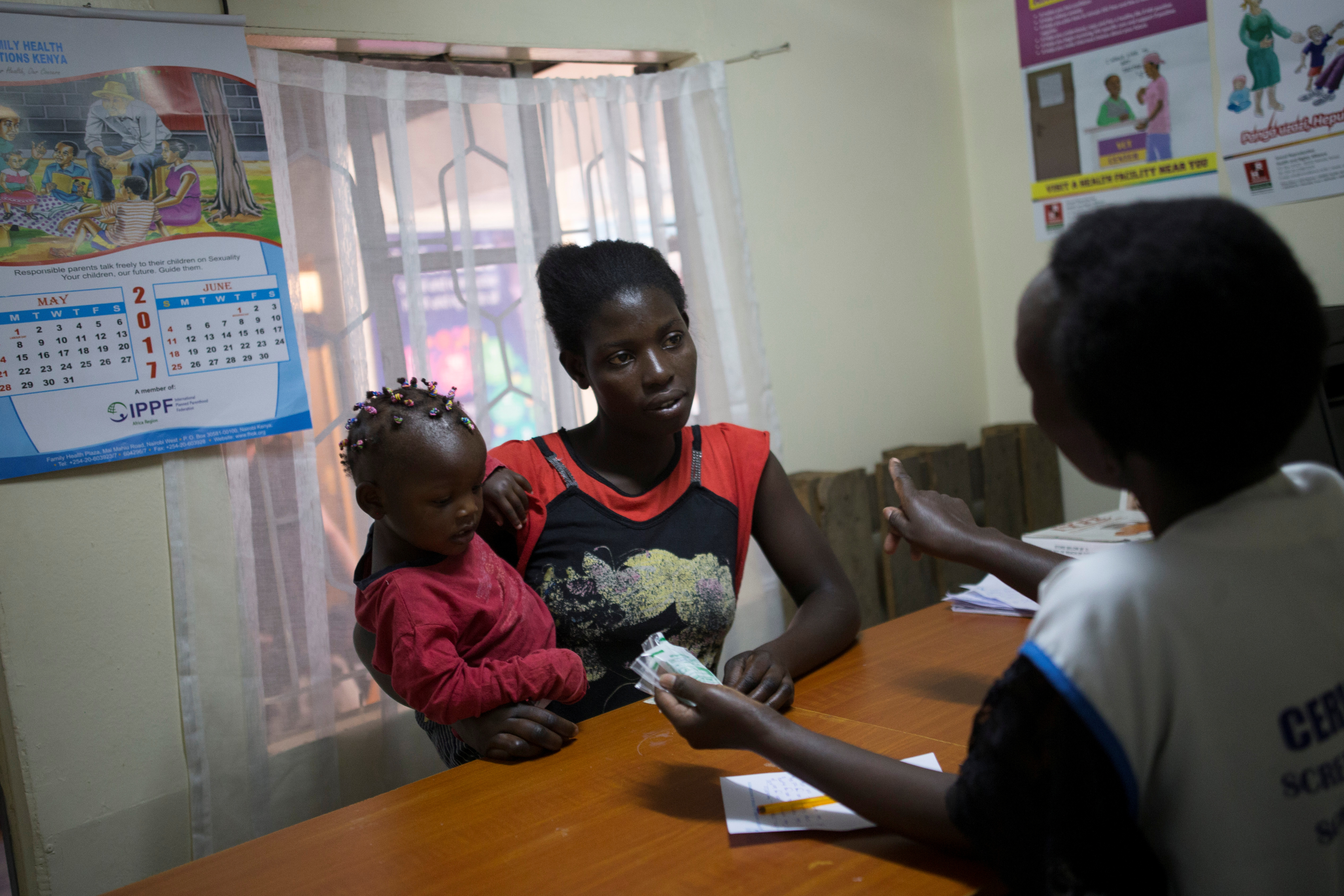 A patient talks to a health worker at the Family Health Options clinic in Nairobi, Kenya, May 16, 2017. REUTERS/Baz Ratner
