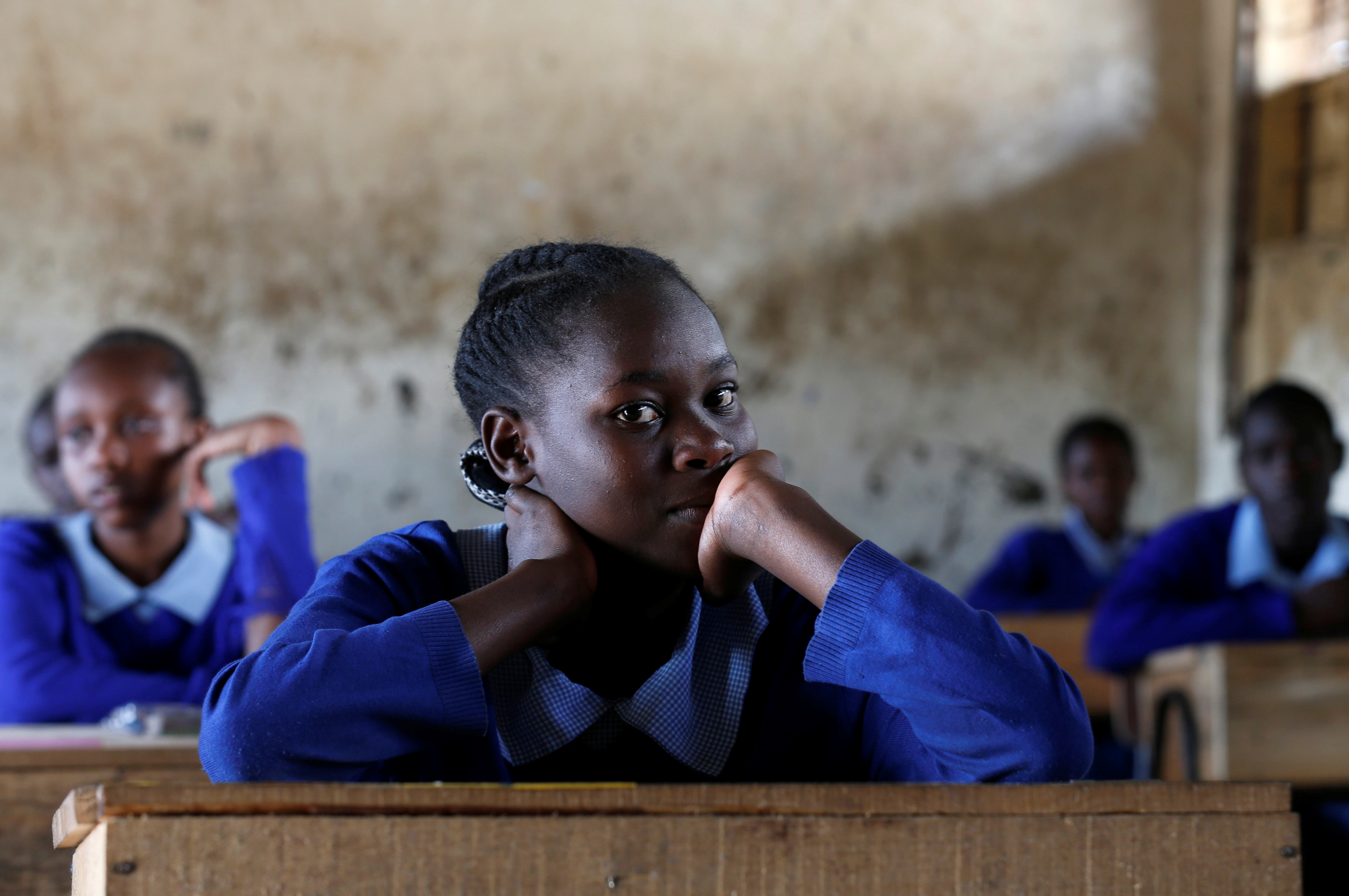 A pupil sits inside a classroom ahead of the primary school final national examinations at Kiboro Primary school along Juja road in Nairobi, Kenya October 31, 2017. REUTERS/Thomas Mukoya