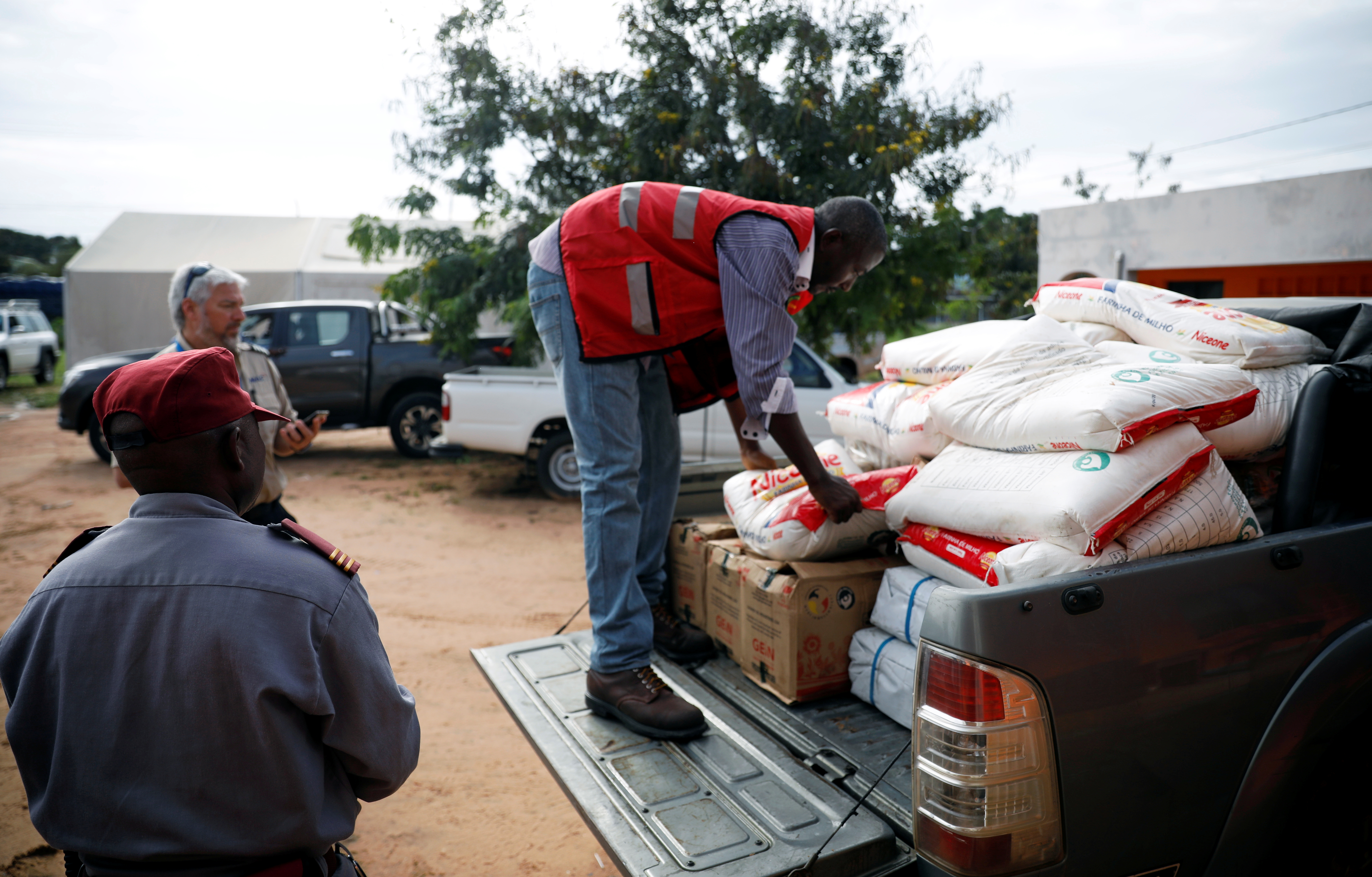 Aid workers load food onto a truck as flooding spreads in the aftermath of Cyclone Kenneth in Pemba, Mozambique, April 29, 2019. REUTERS/Mike Hutchings