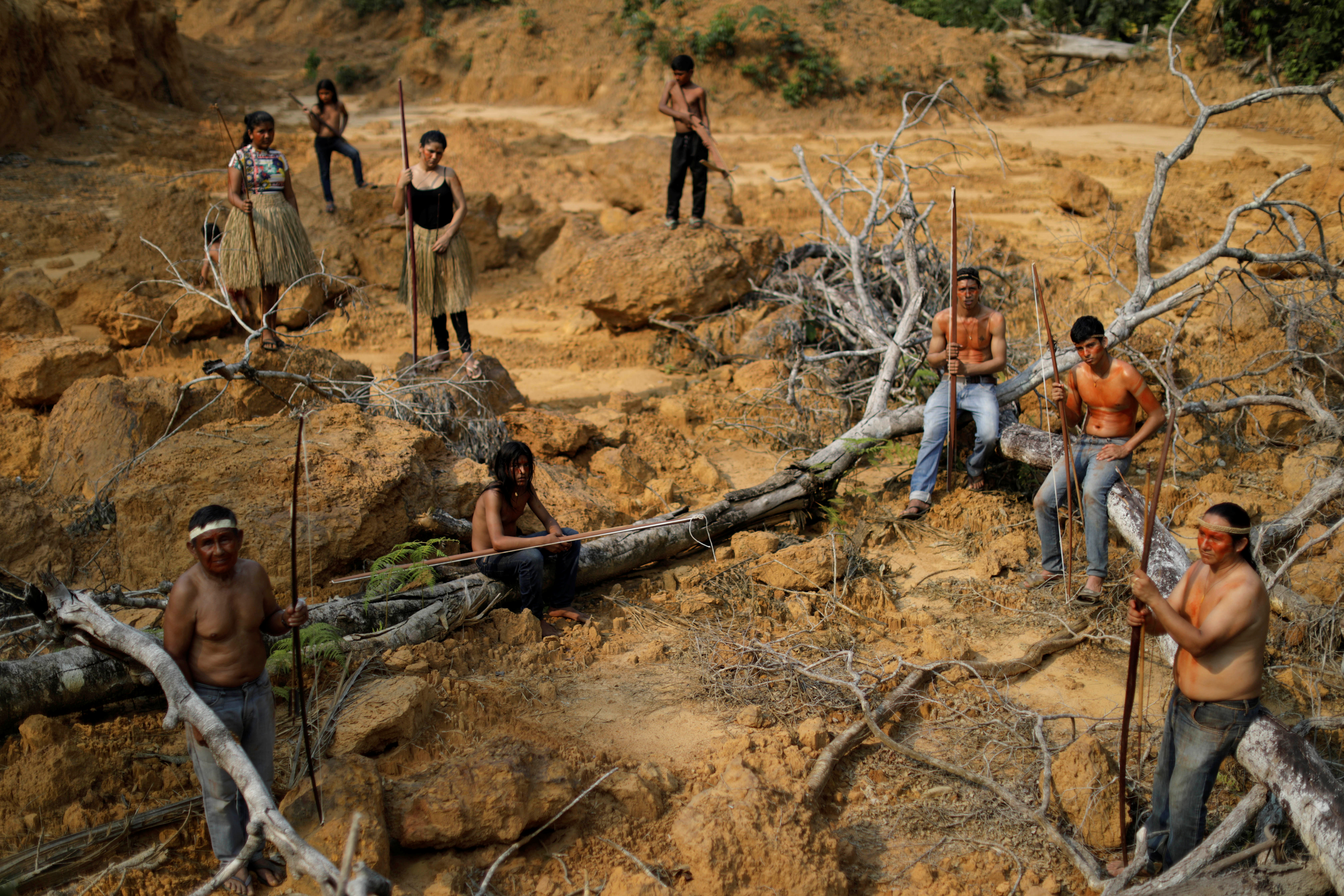 Indigenous people from the Mura tribe show a deforested area in unmarked indigenous lands inside the Amazon rainforest near Humaita, Amazonas State, Brazil August 20, 2019