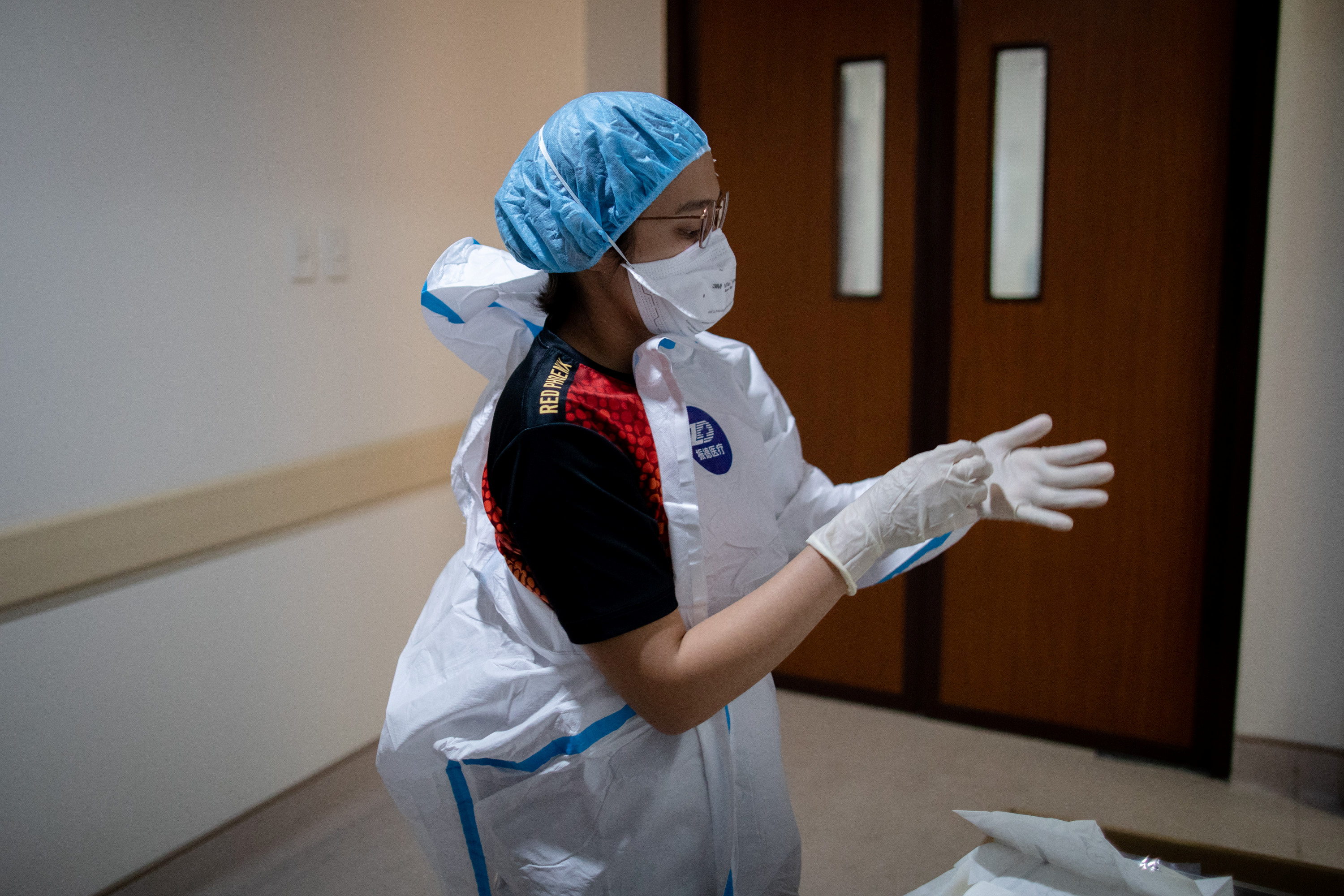 A doctor puts on personal protective equipment in the Emergency Room of East Avenue Medical Center, in Quezon City, Metro Manila, Philippines, June 26, 2020. REUTERS/Eloisa Lopez