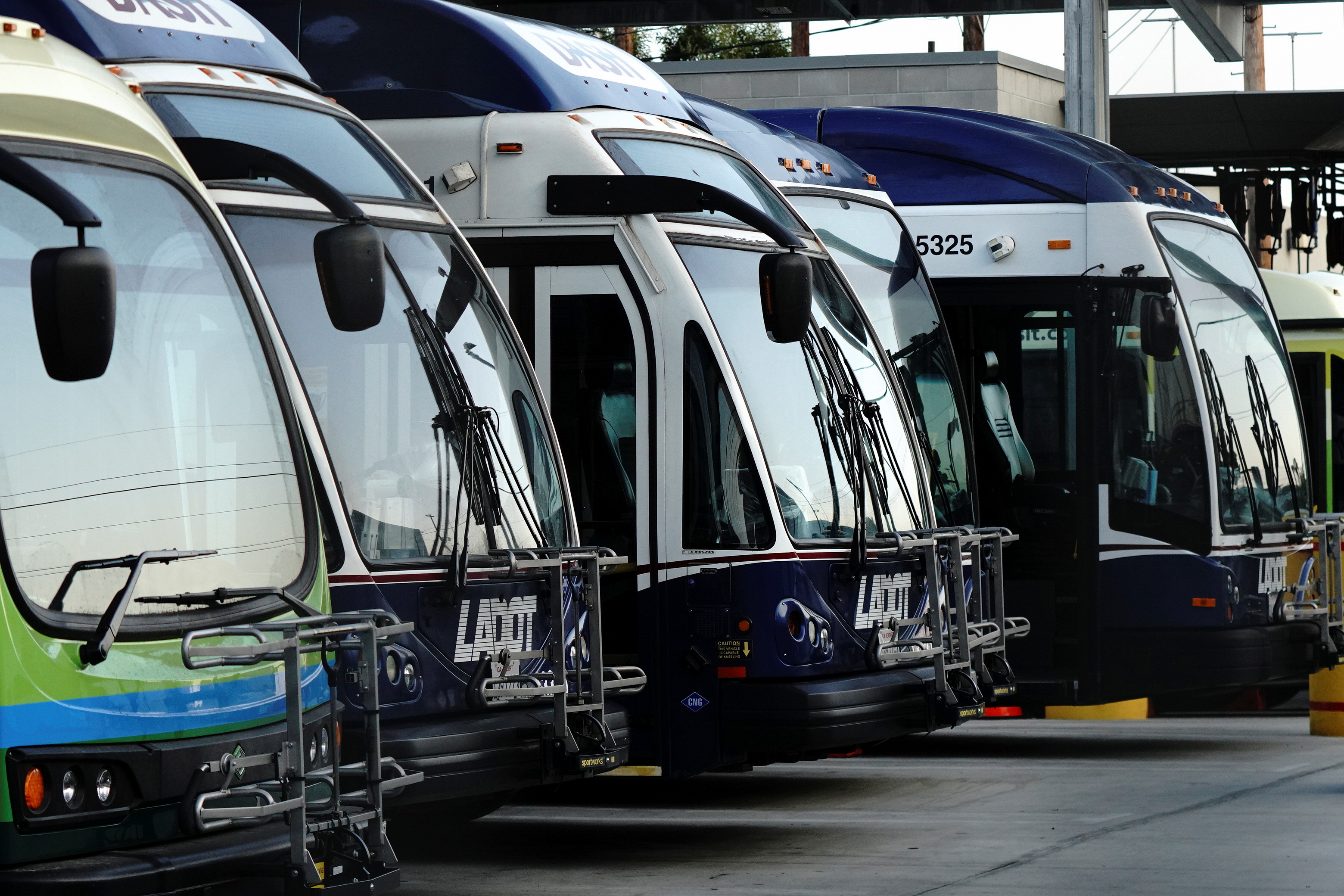 A Proterra Catalyst BE35 electric bus and CNG (compressed natural gas) buses are seen at an L.A. City Transportation Department (LADOT) DASH transit bus maintenance facility in downtown Los Angeles, California, U.S., August 21, 2021. REUTERS/Bing Guan