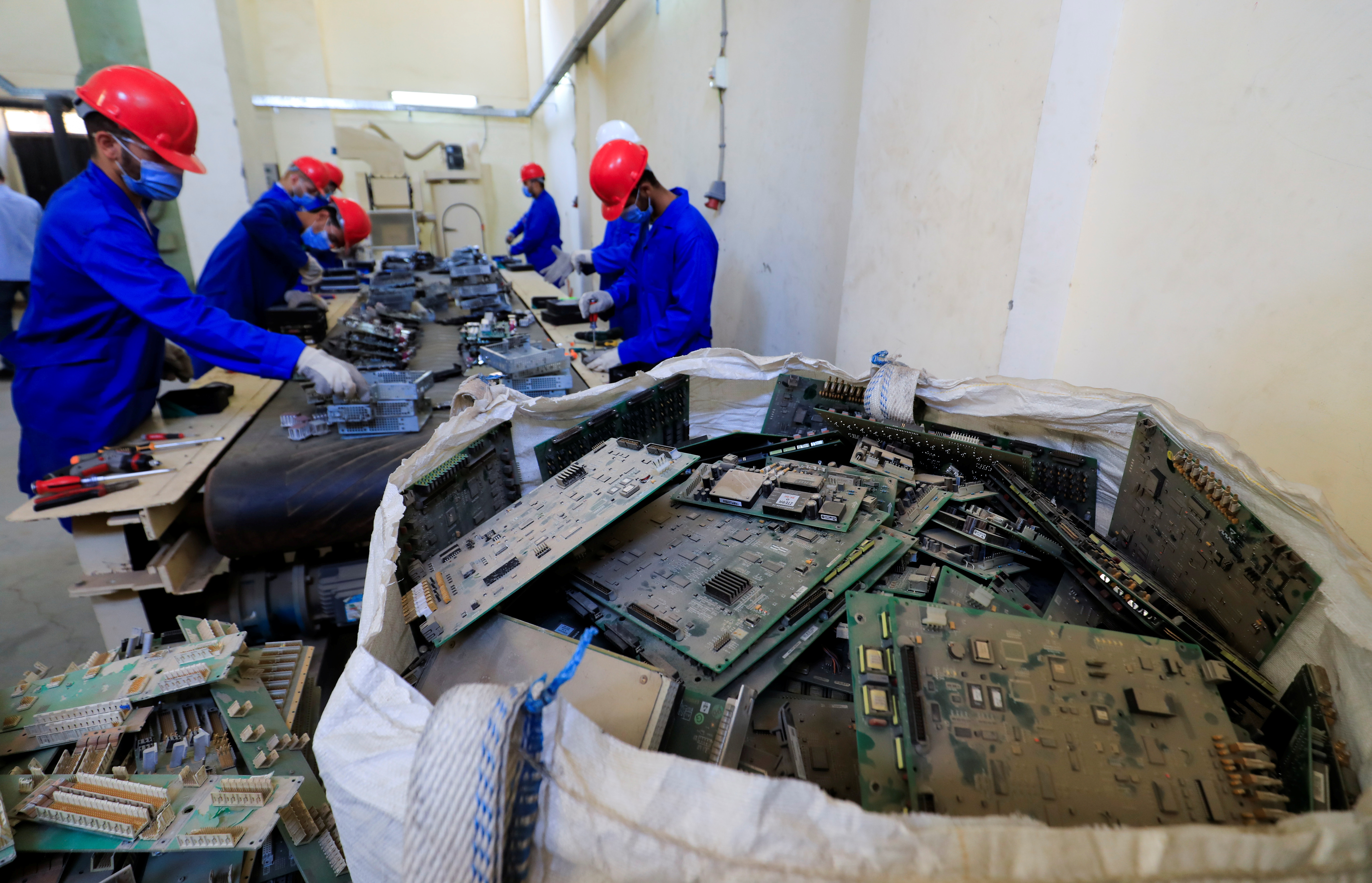 Workers work with parts of different types of electronic machines to be recycled into  precious metals at a factory in Giza, Egypt, August 26, 2021. REUTERS/Amr Abdallah Dalsh