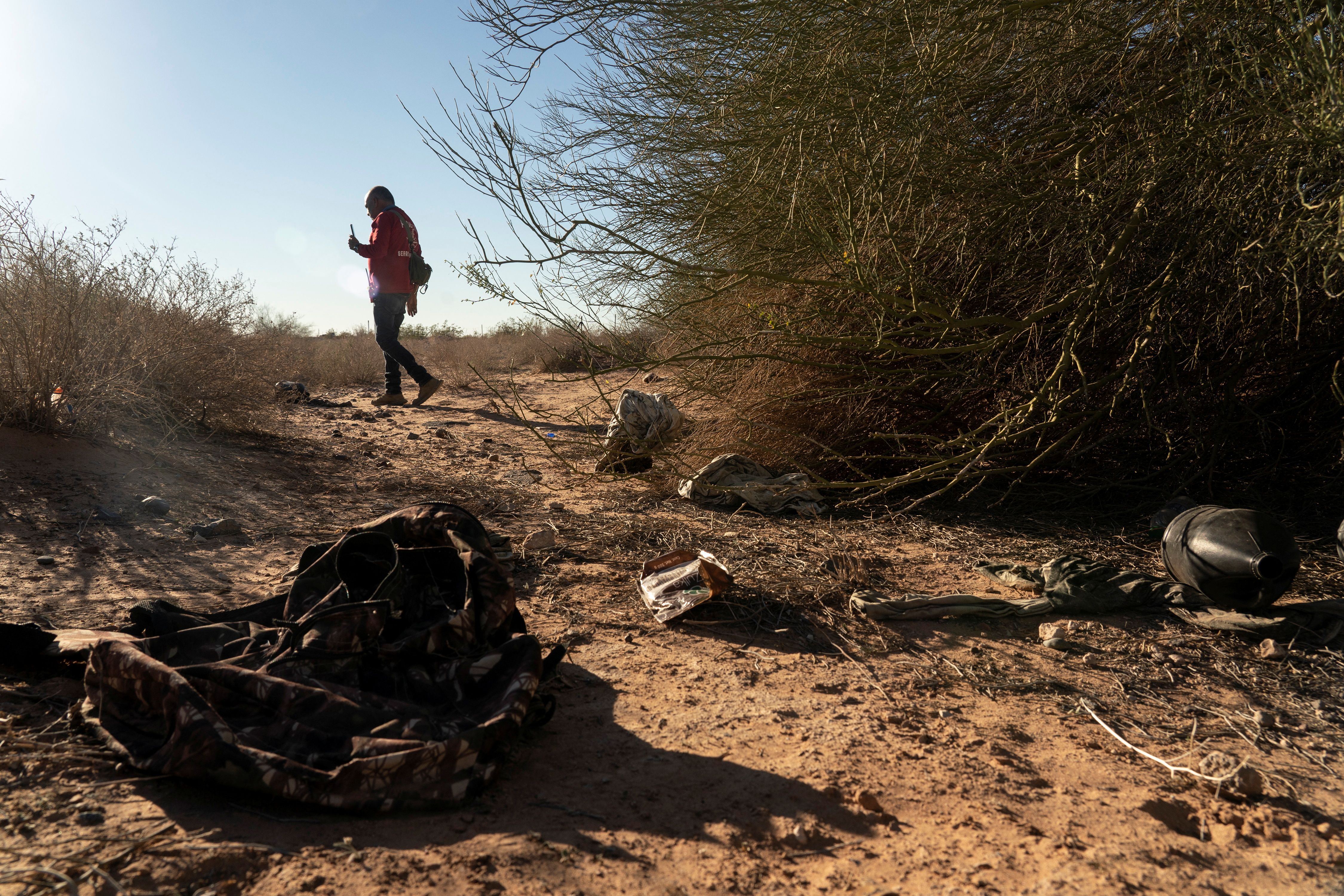 Member of the search and rescue team Paralelo 31, walks in a desert while on a search mission for the corpse of migrants in Agua Caliente, Arizona, U.S., February 19, 2022