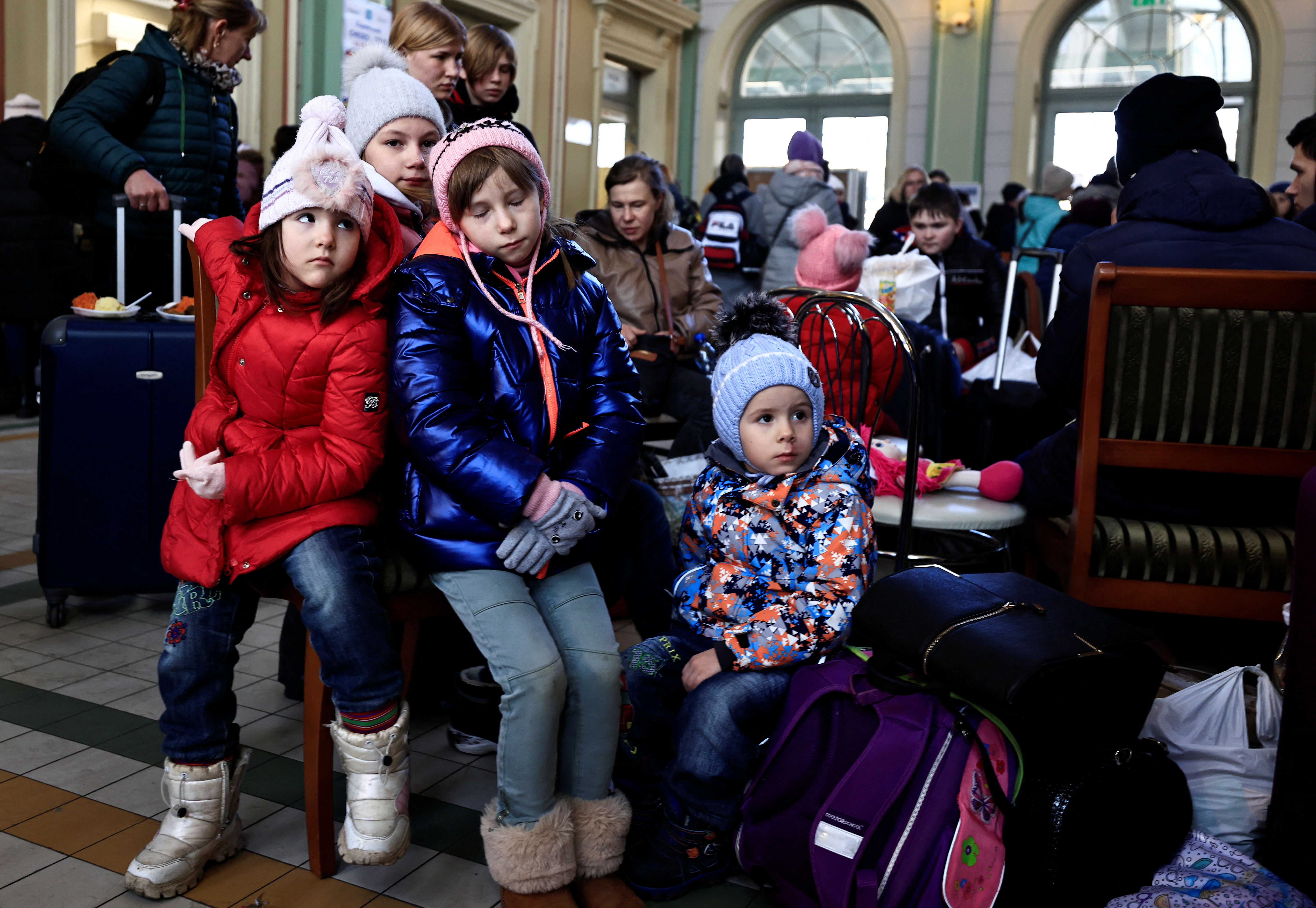 Girls rest at a train station, after fleeing Russia's invasion of Ukraine, in Przemysl, Poland, March 17, 2022. REUTERS/Zohra Bensemra