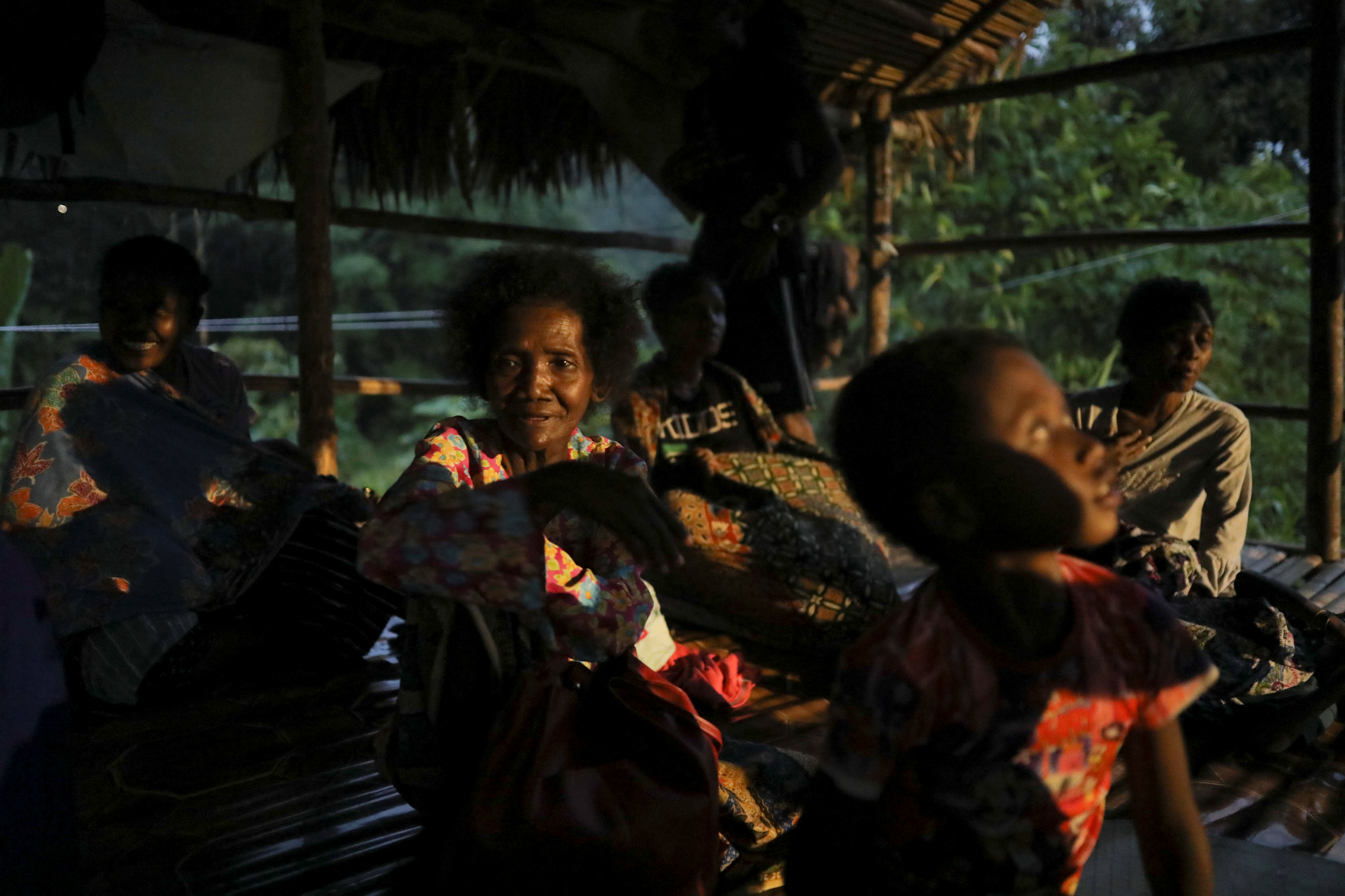 A Batek indigenous woman, spends her evening in a hut along with other indigenous people, at the fringe of Malaysia's National Park in Gua Musang, Kelantan, Malaysia, May 30, 2022. REUTERS/Hasnoor Hussain
