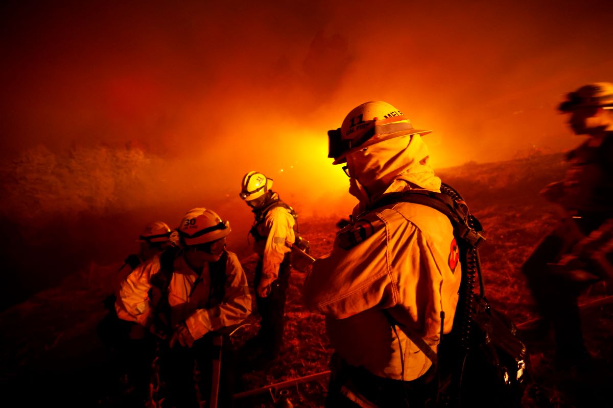 Firefighters monitor fire near structures, as the Mosquito Fire burns in Foresthill, California, U.S., September 13, 2022. REUTERS/Fred Greaves