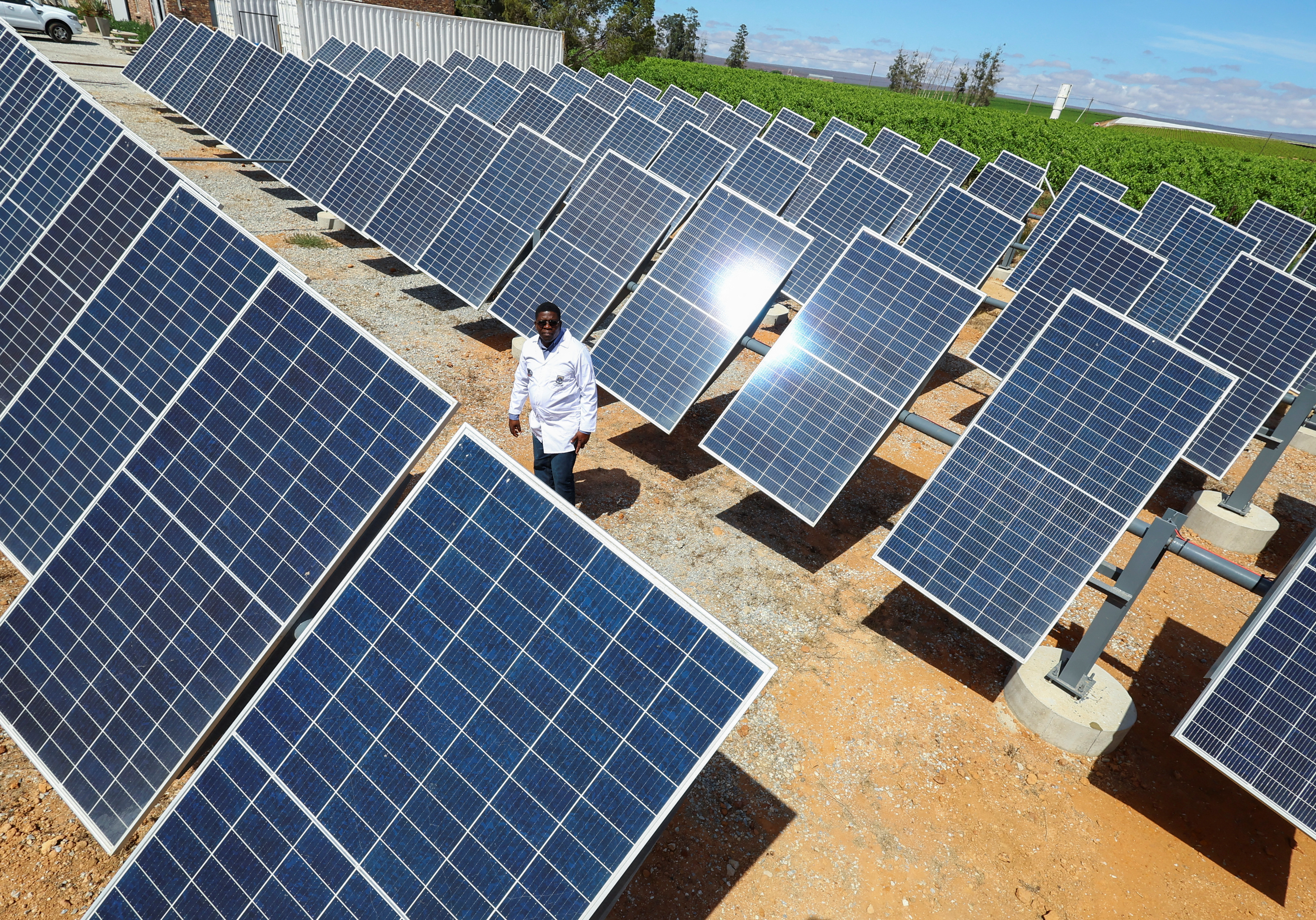 A man looks at the solar panels at a green hydrogen production facility at Namaqua Engineering in Vredendal, South Africa, November 15, 2022. REUTERS/Esa Alexander