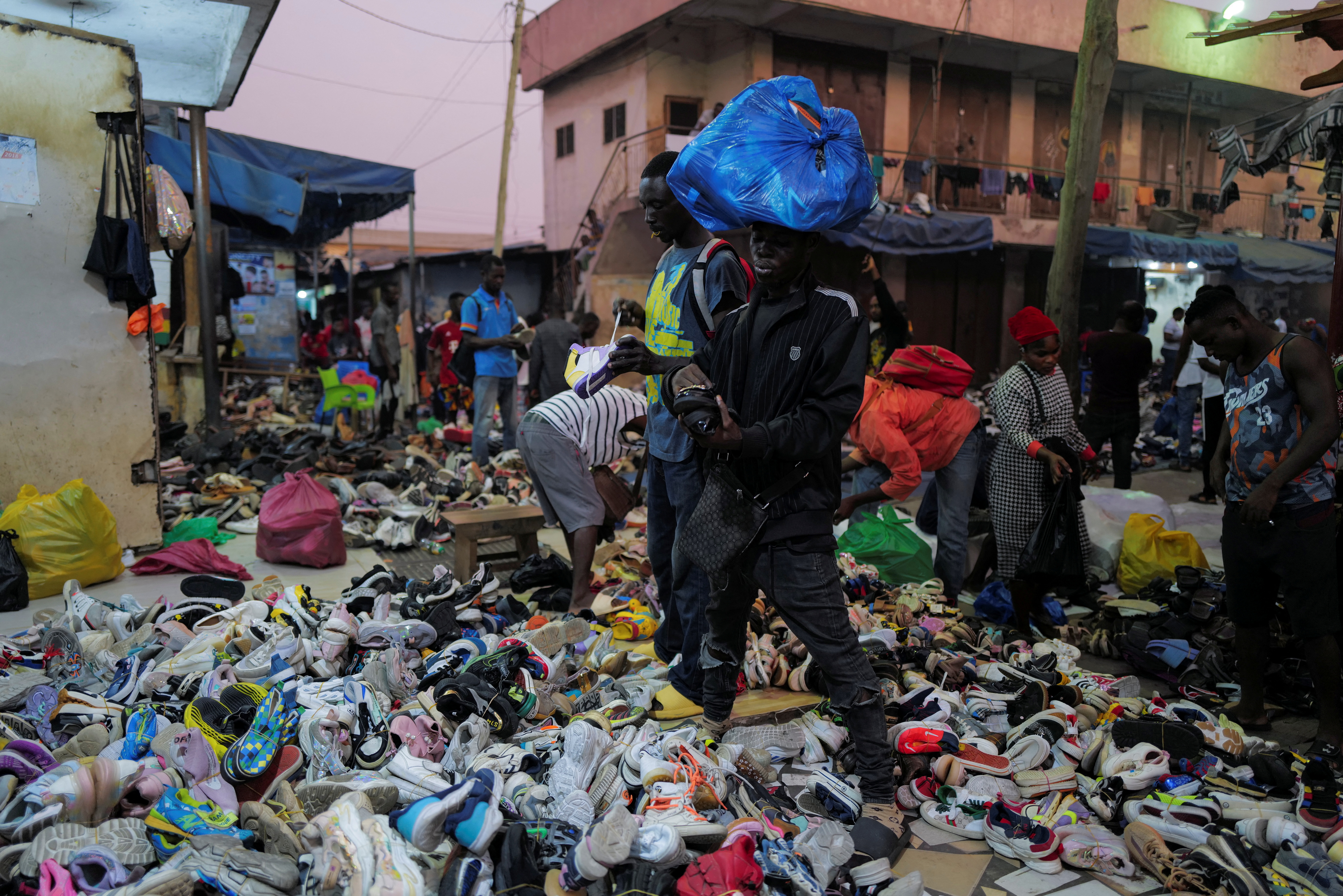 Shoppers buy second-hand shoes at the Kantamanto market in Accra, Ghana, November 30, 2022. REUTERS/Francis Kokoroko