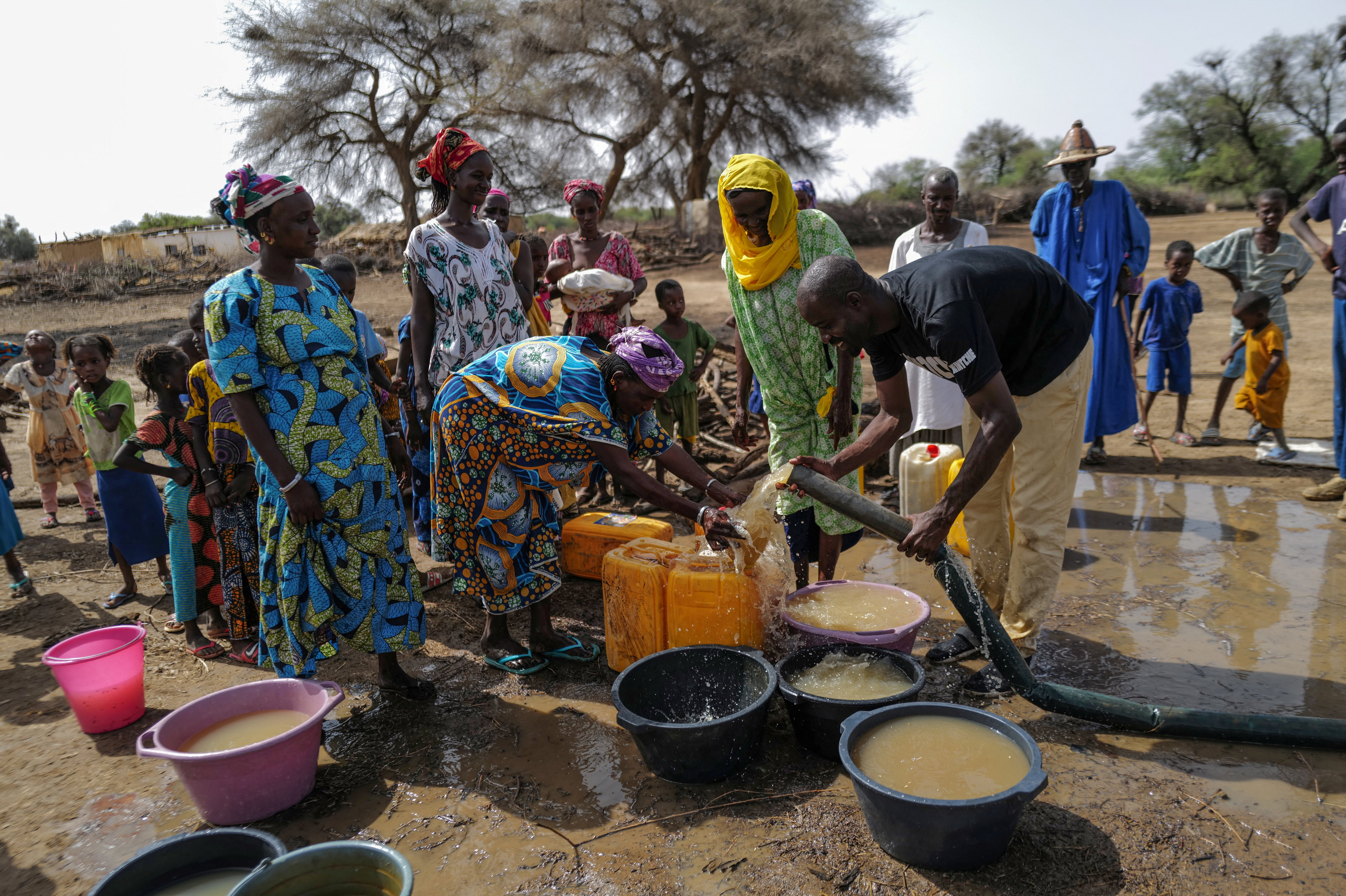 People pump water from a well that is being constructed in Ourou Amady Bagga, Podor region, Senegal July 8, 2023. REUTERS/Zohra Bensemra