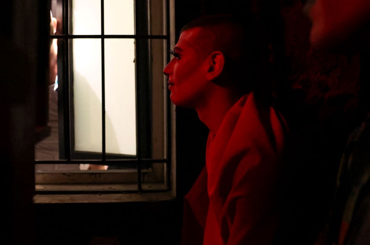 Drag artist known as Latiza Bombe hides on the terrace of a bar after they were attacked by a group of conservative Christians who identify as "the Soldiers of God", in Beirut, Lebanon August 23, 2023. REUTERS/Emilie Madi