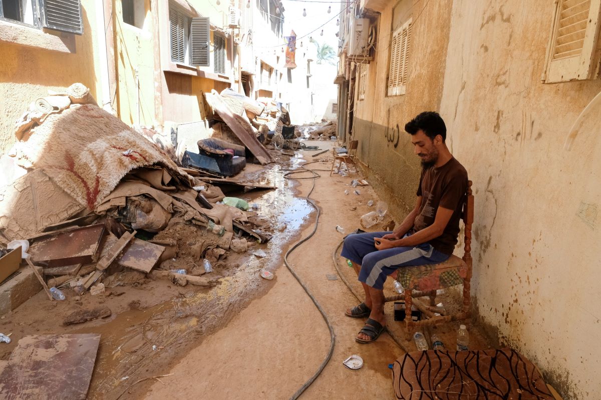 A man sits in front of his house that was impacted by fatal floods in Derna, Libya, September 28, 2023
