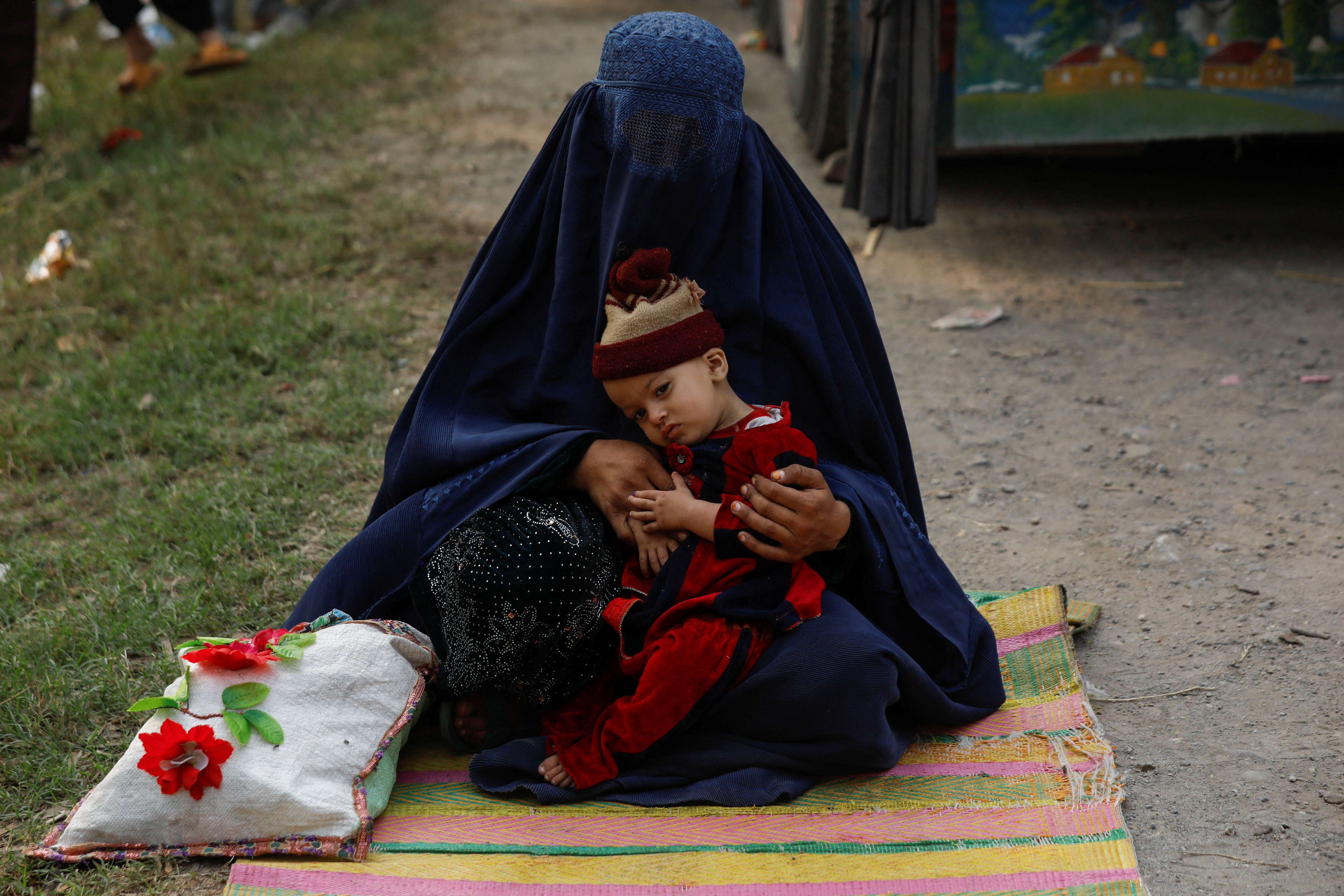 An Afghan refugee woman sits with her daughter as Pakistan warns undocumented immigrants to leave in Azakhel town in Nowshera, Pakistan October 30, 2023. REUTERS/Fayaz Aziz