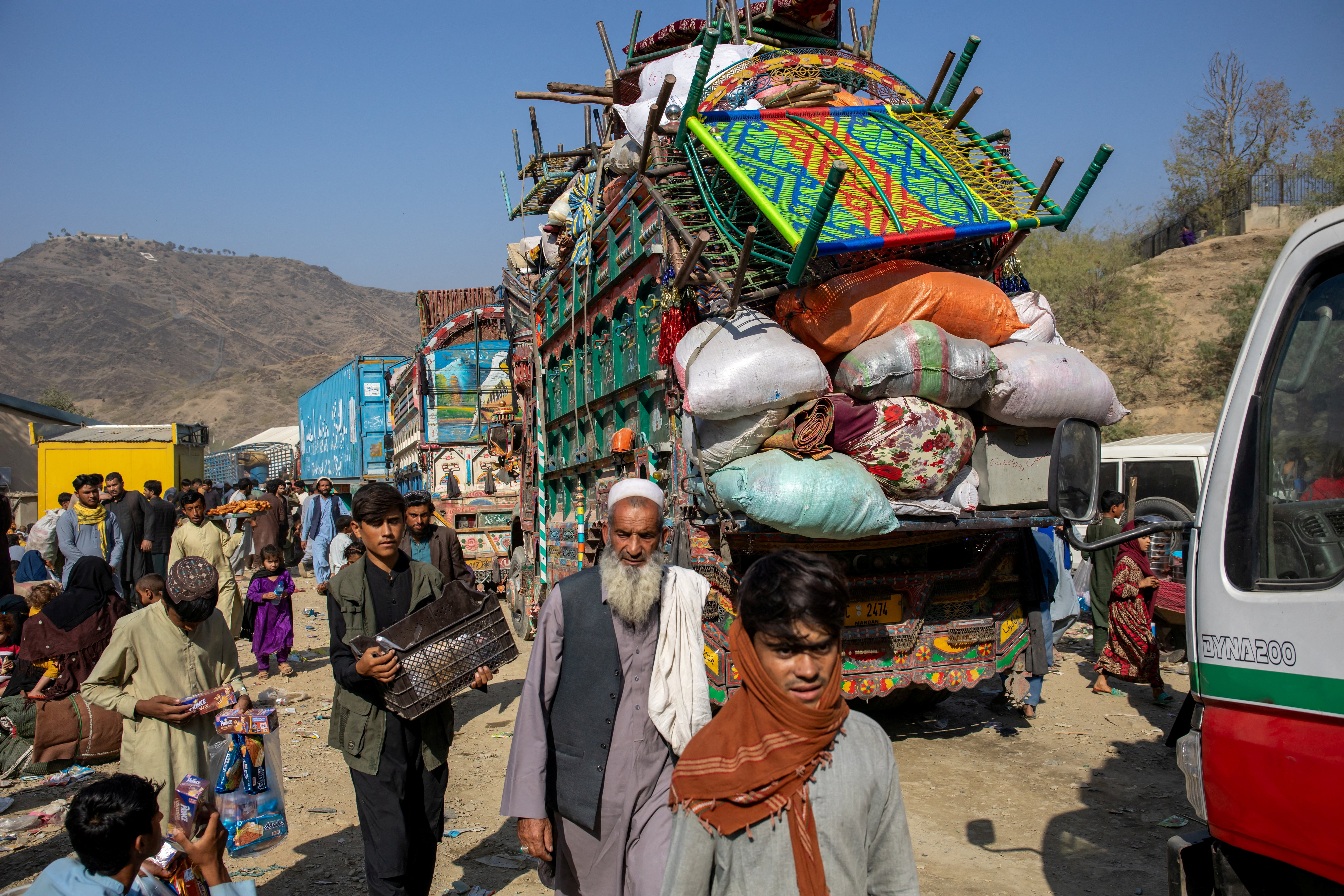 Trucks loaded with goods are seen at the Torkham border as Afghan nationals head back to Afghanistan, at the Torkham border crossing between Pakistan and Afghanistan, October 30, 2023. The Norwegian Refugee Council/Handout via REUTERS