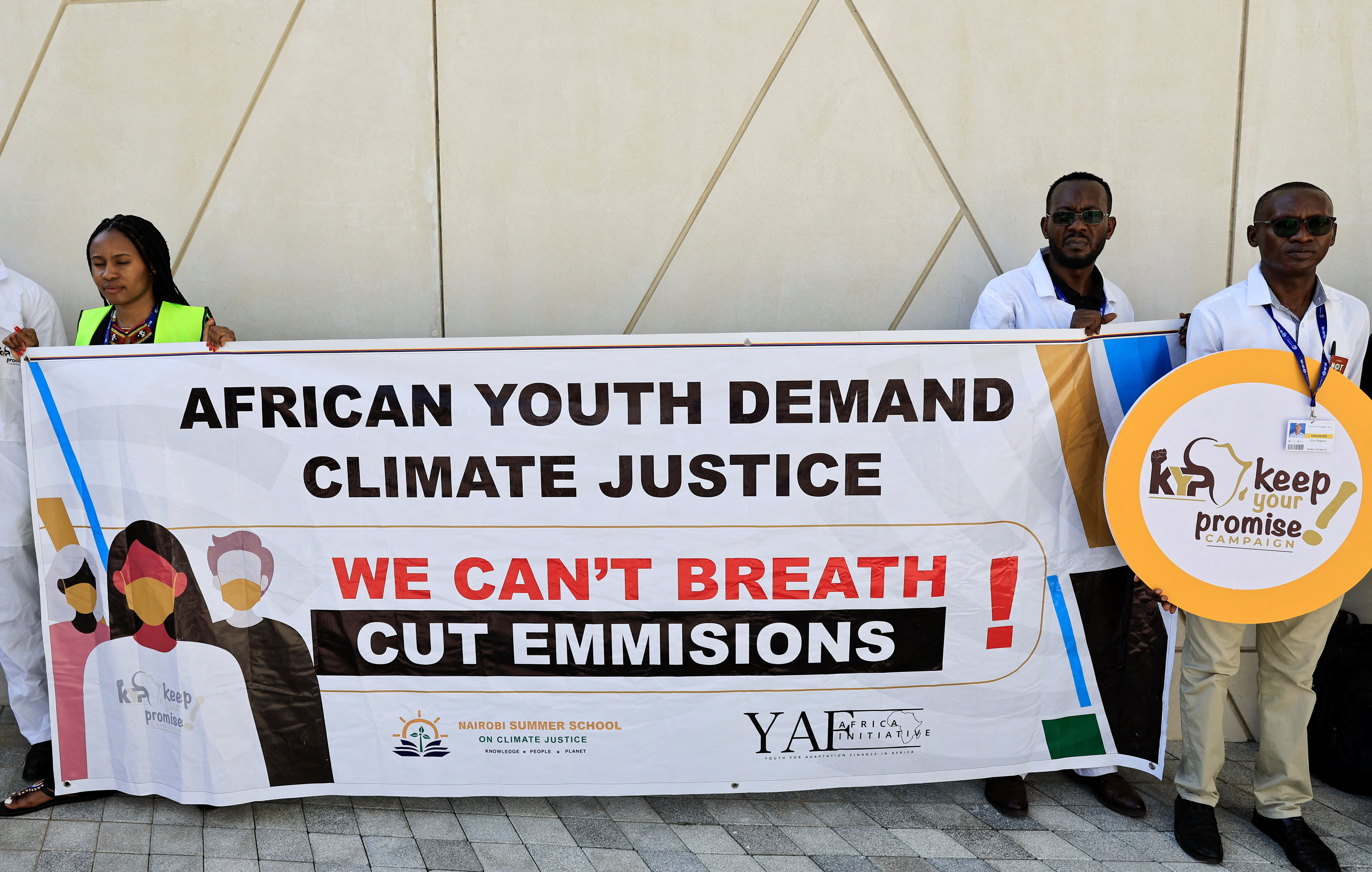 Activists hold a sign that reads "African youth demand climate justice" during a protest, at the United Nations Climate Change Conference COP28 in Dubai, United Arab Emirates, December 5, 2023. REUTERS/Thaier Al-Sudani