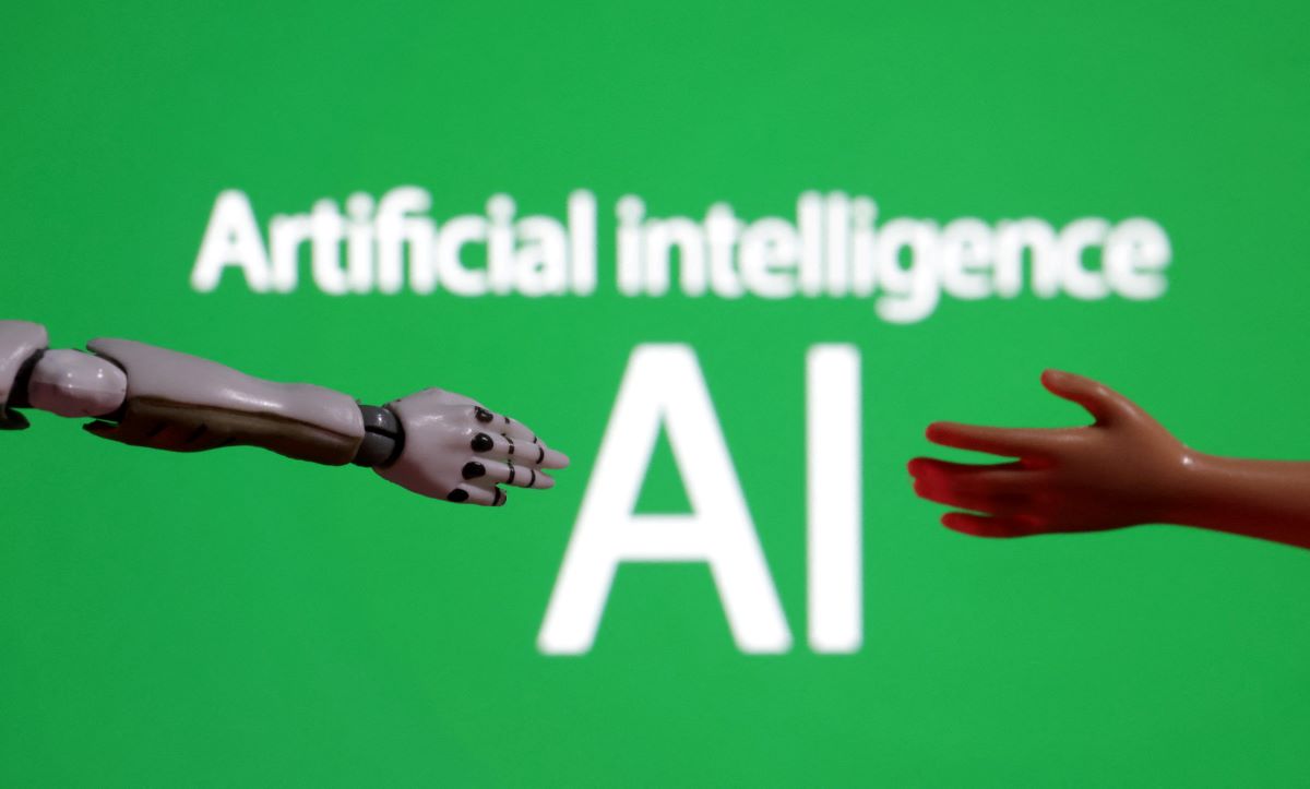Words reading "Artificial intelligence AI", miniature of robot and toy hand are pictured in this illustration taken December 14, 2023. REUTERS/Dado Ruvic