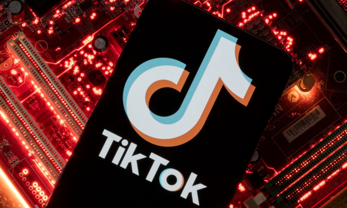 A smartphone with a displayed TikTok logo is placed on a computer motherboard in this illustration taken February 23, 2023. REUTERS/Dado Ruvic