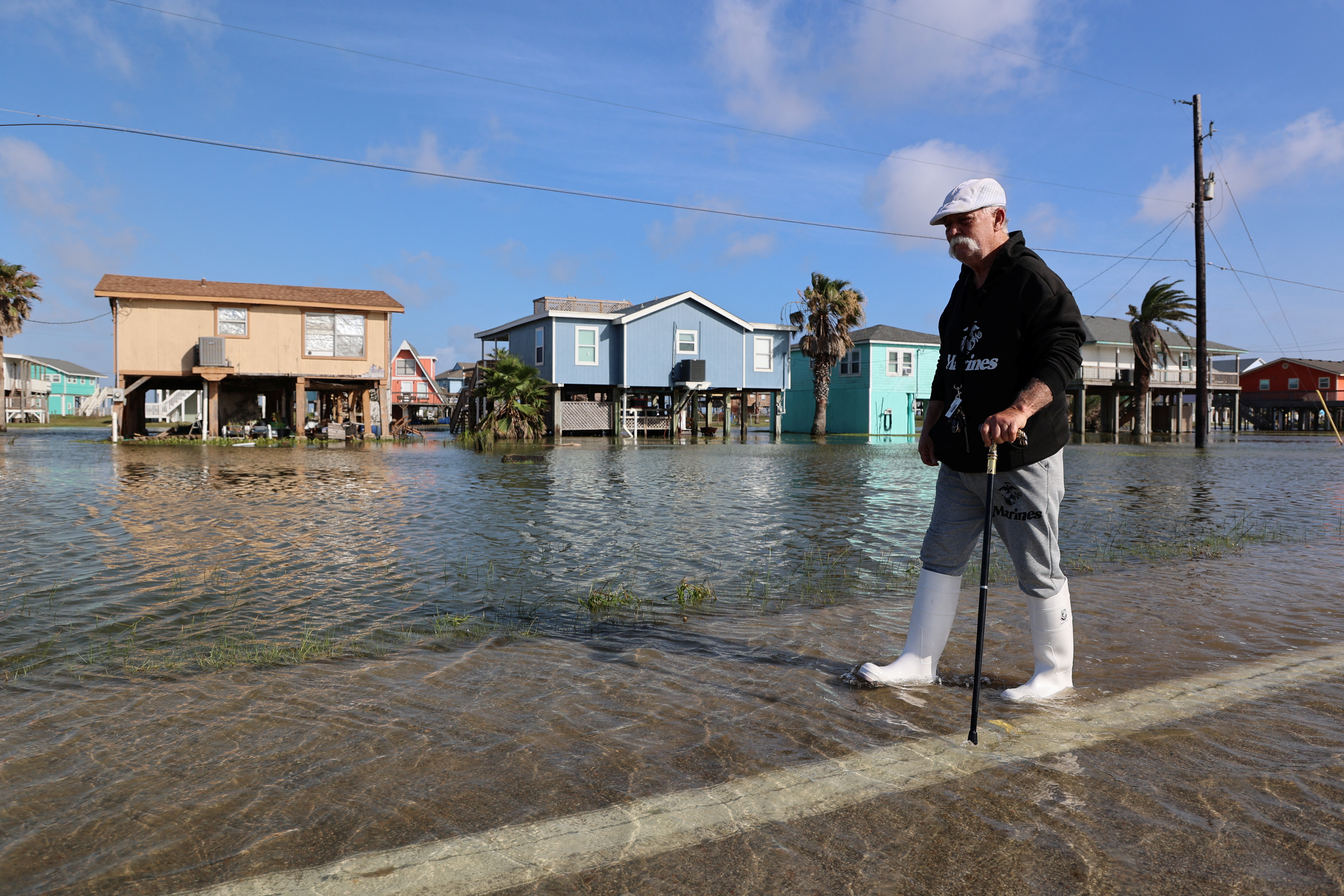 A resident walks through floodwaters outside his home in Surfside Beach, Texas, U.S. June 20, 2024 . REUTERS/Evan Garcia