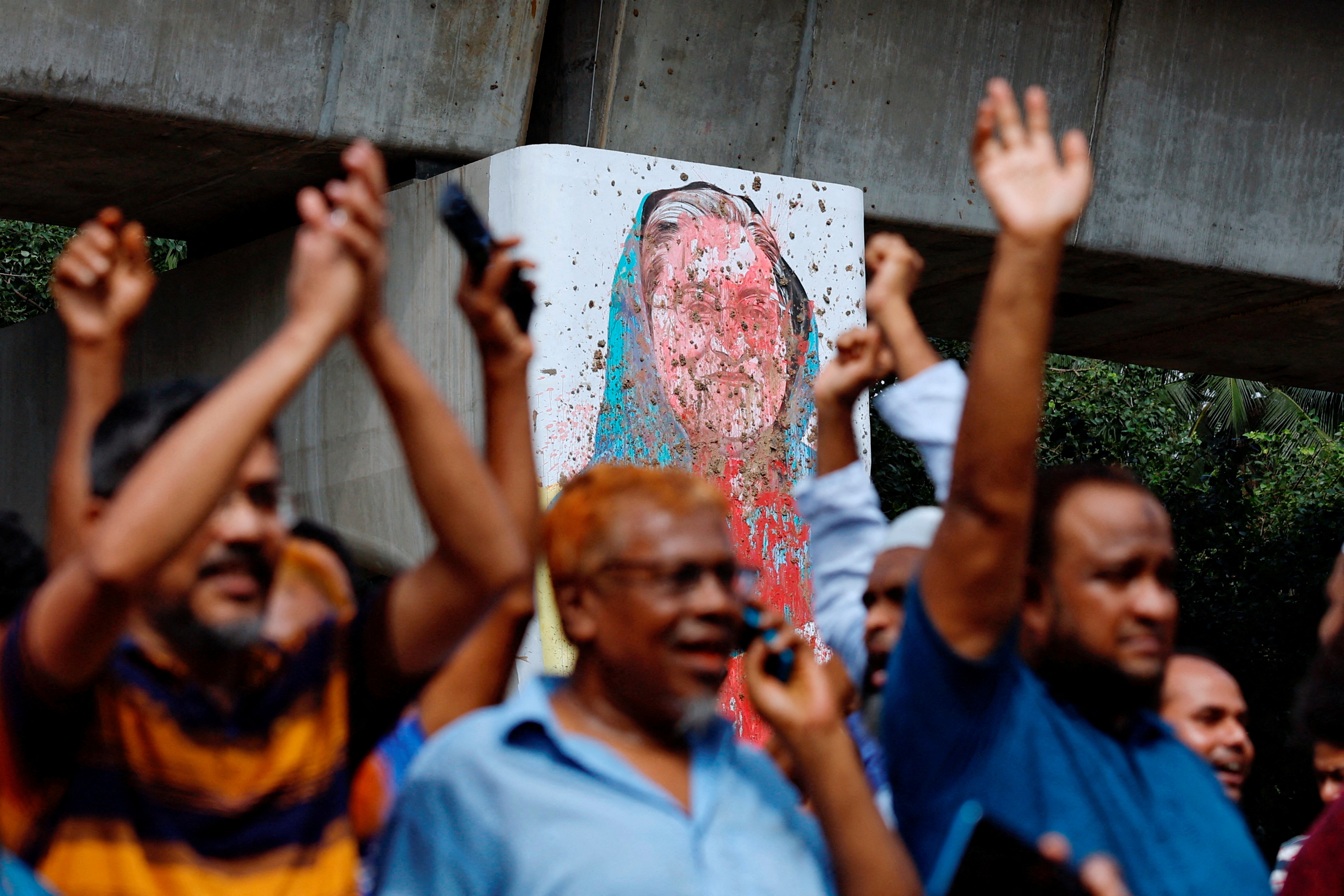 A mural of Prime Minister Sheikh Hasina is seen vandalised by protesters as people celebrate her resignation in Dhaka, Bangladesh, August 5, 2024. REUTERS/Mohammad Ponir Hossain