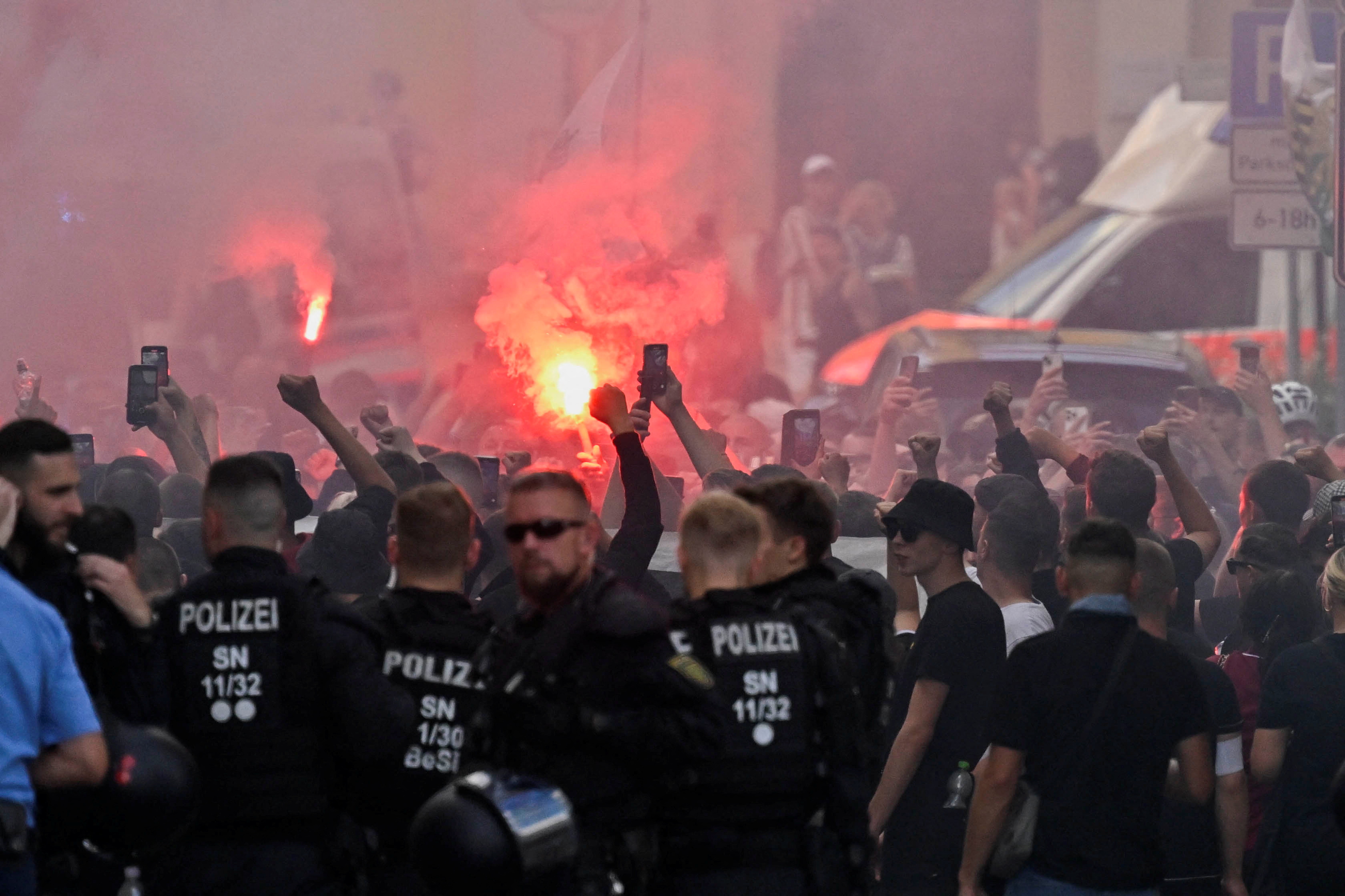 Flares burn as right-wing supporters protest during the annual Christopher Street Day (CSD) LGBTQ+ Pride march, in Bautzen, Germany August 10, 2024. REUTERS/Matthias Rietschel