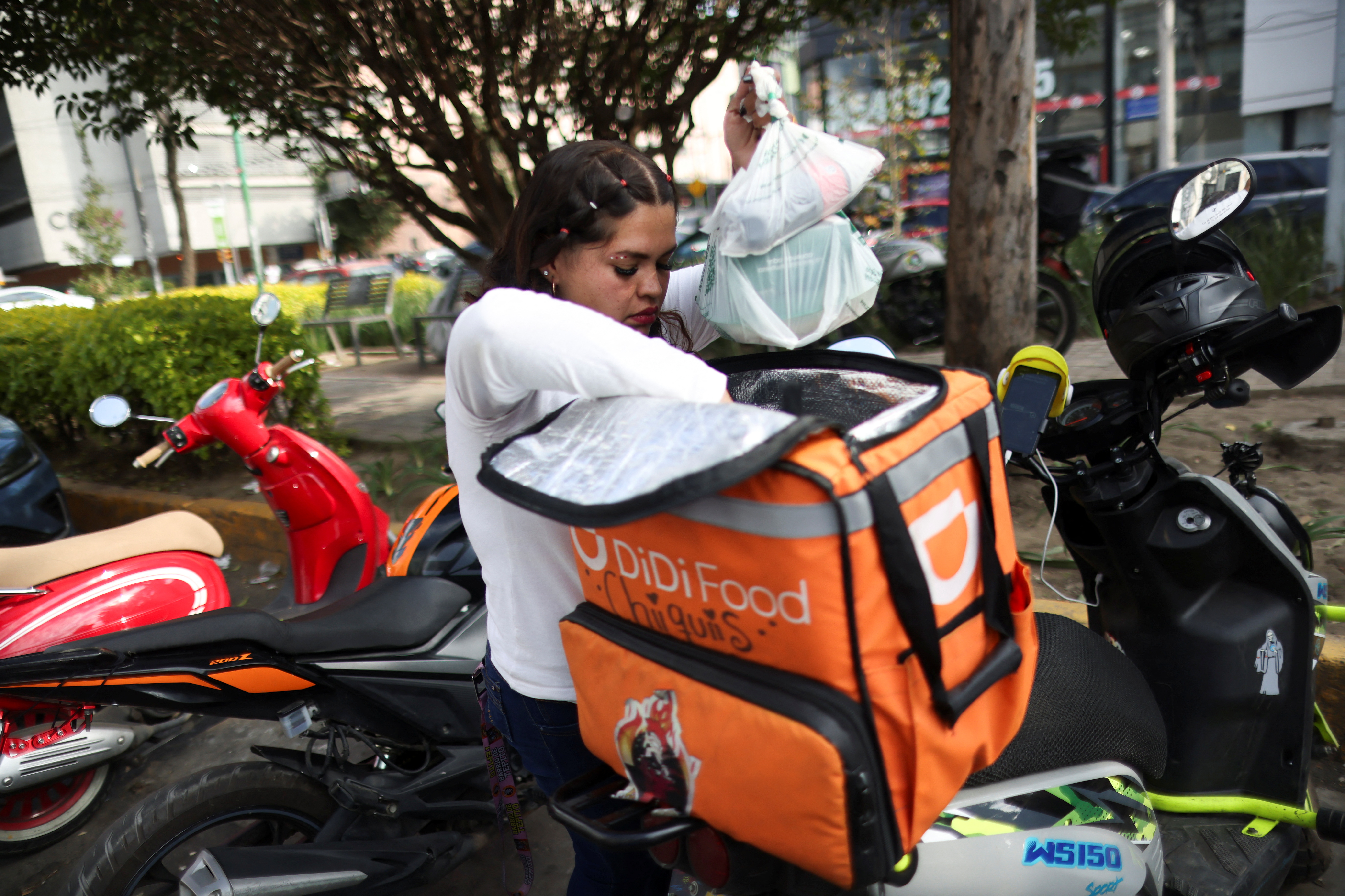 A delivery driver for Didi Food gets ready to deliver a food order in Mexico City, Mexico October 16, 2024. REUTERS/Gustavo Graf