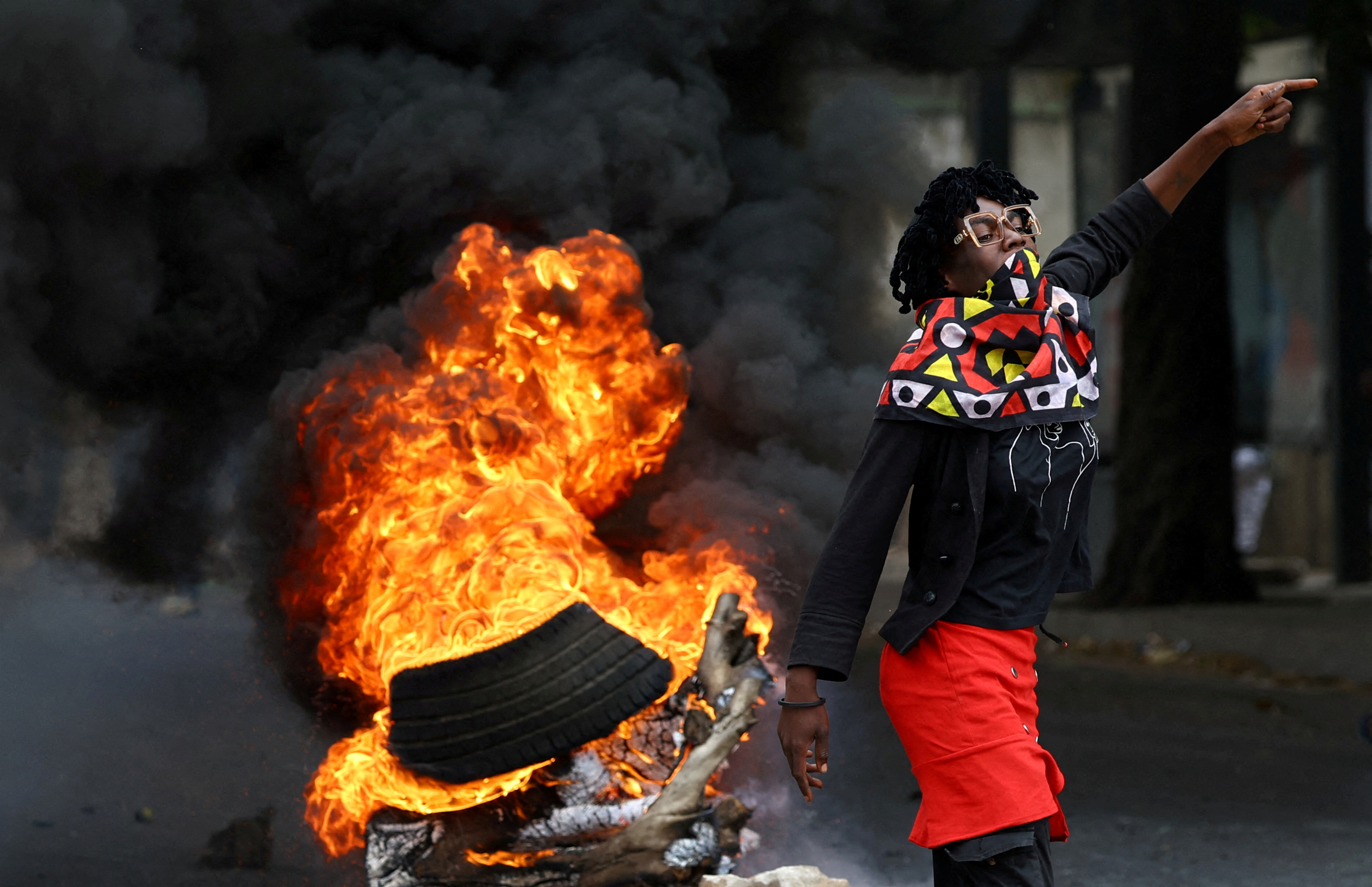 A protester reacts near a burning barricade during a "national shutdown" against the election outcome, at Luis Cabral township in Maputo, Mozambique, November 7, 2024. REUTERS/Siphiwe Sibeko