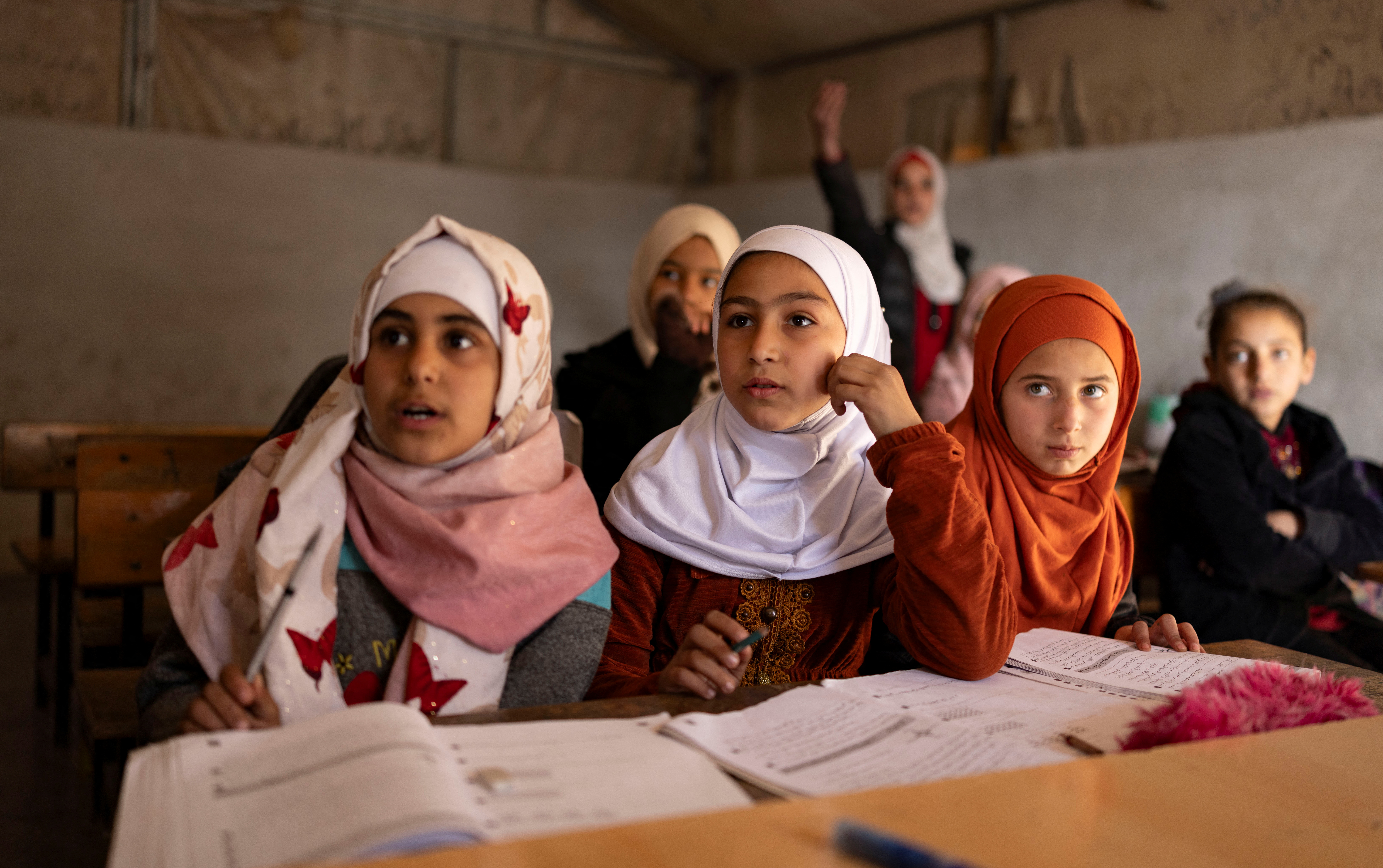 Children attend a class in a primary school at refugee camp in Idlib, Syria, December 17, 2024. REUTERS/Umit Bektas