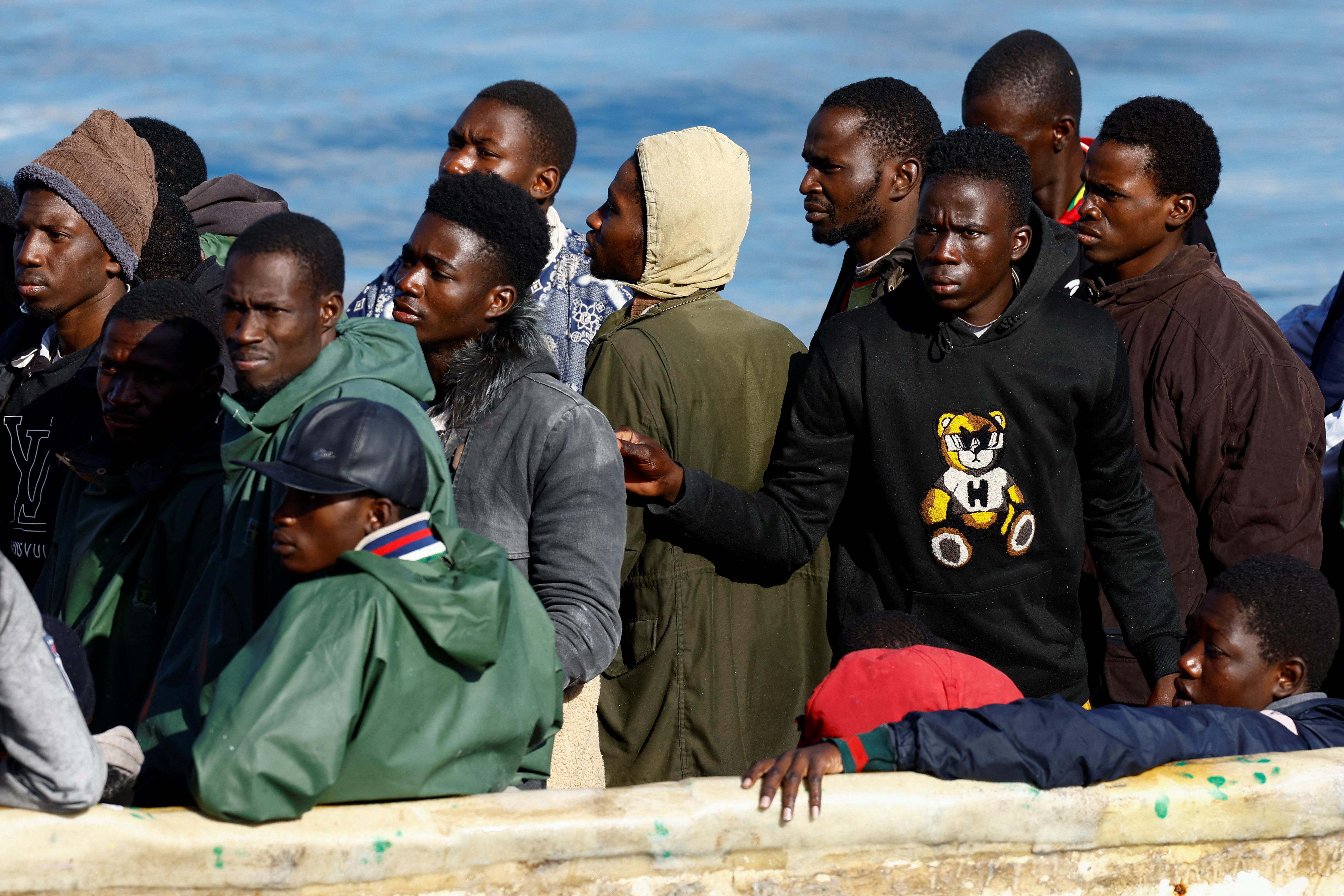 A Spanish Coast Guard vessel tows a fibreglass boat with migrants onboard to the port of Arguineguin, on the island of Gran Canaria, Spain, December 25, 2024. REUTERS/Borja Suarez