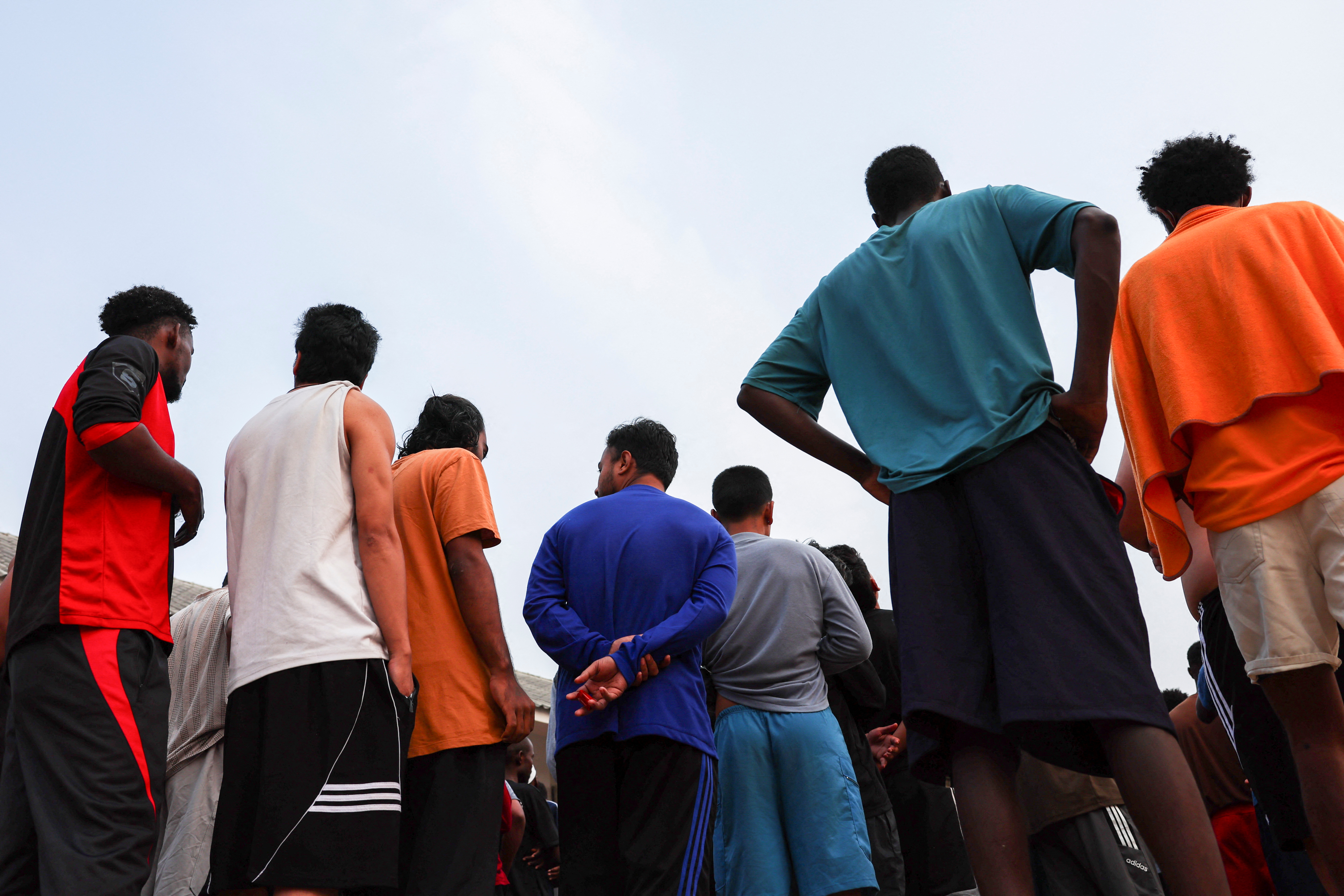 Multinational victims of scam centres queue to get food at a shelter as they wait for their embassies to pick them up, in Tak province, Thailand February 19, 2025. REUTERS/Chalinee Thirasupa