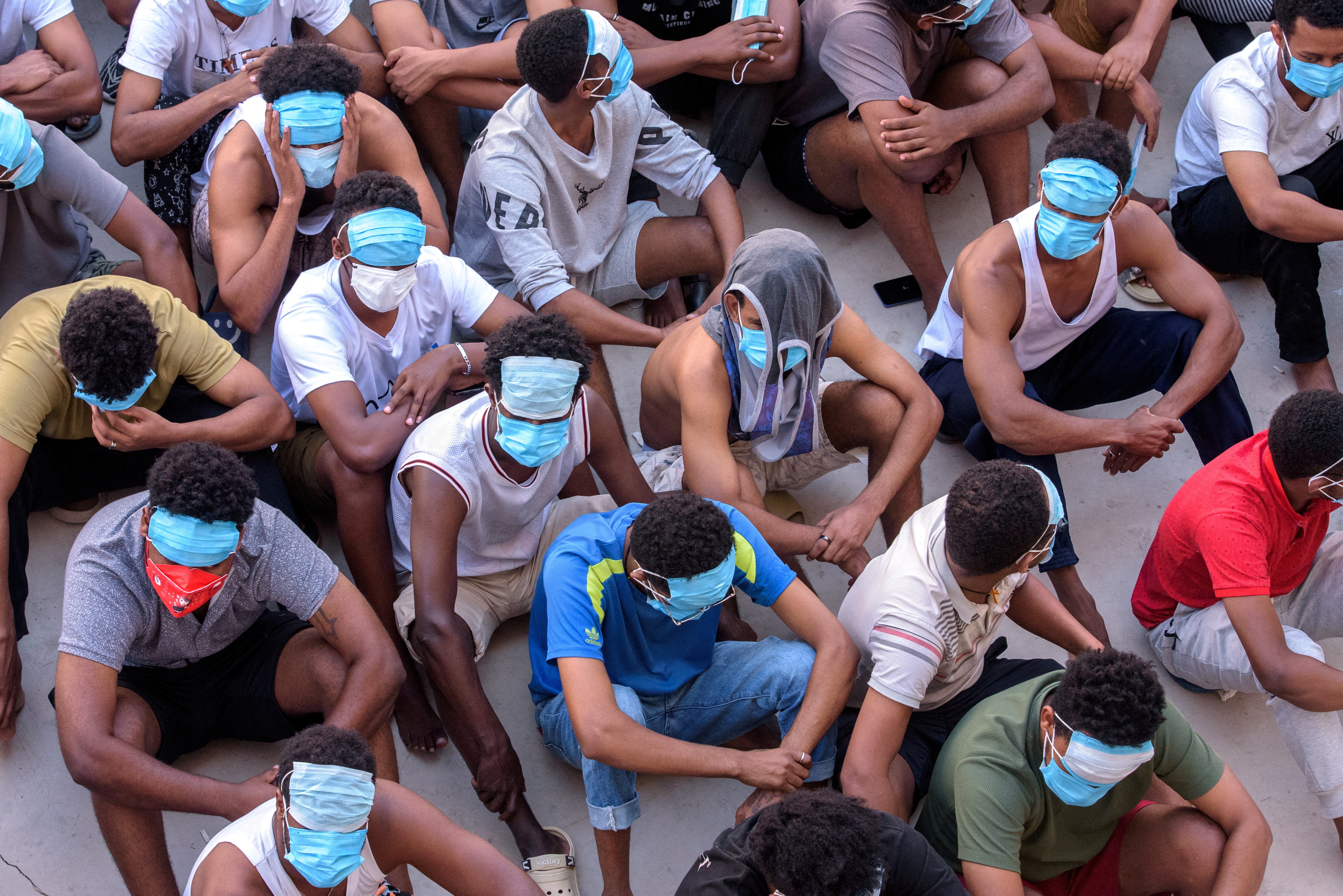 Victims of scam centers wait at a compound inside the KK Park, a fraud factory, and a human trafficking hub on the border with Thailand-Myanmar in Myawaddy, Myanmar, February 26, 2025. REUTERS/Stringer