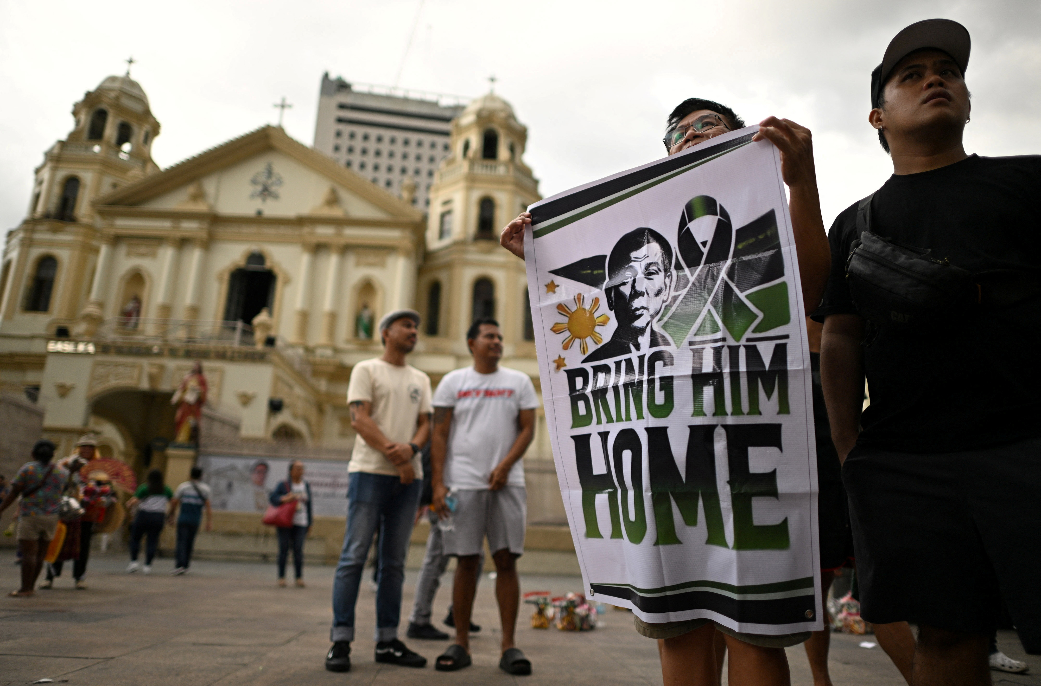 Supporters of former Philippine President Rodrigo Duterte hold a banner during a rally to celebrate his 80th birthday, as he remains in ICC custody over war crimes allegations, in front of Quiapo Church in Manila, Philippines, March 28, 2025. REUTERS/Noel Celis