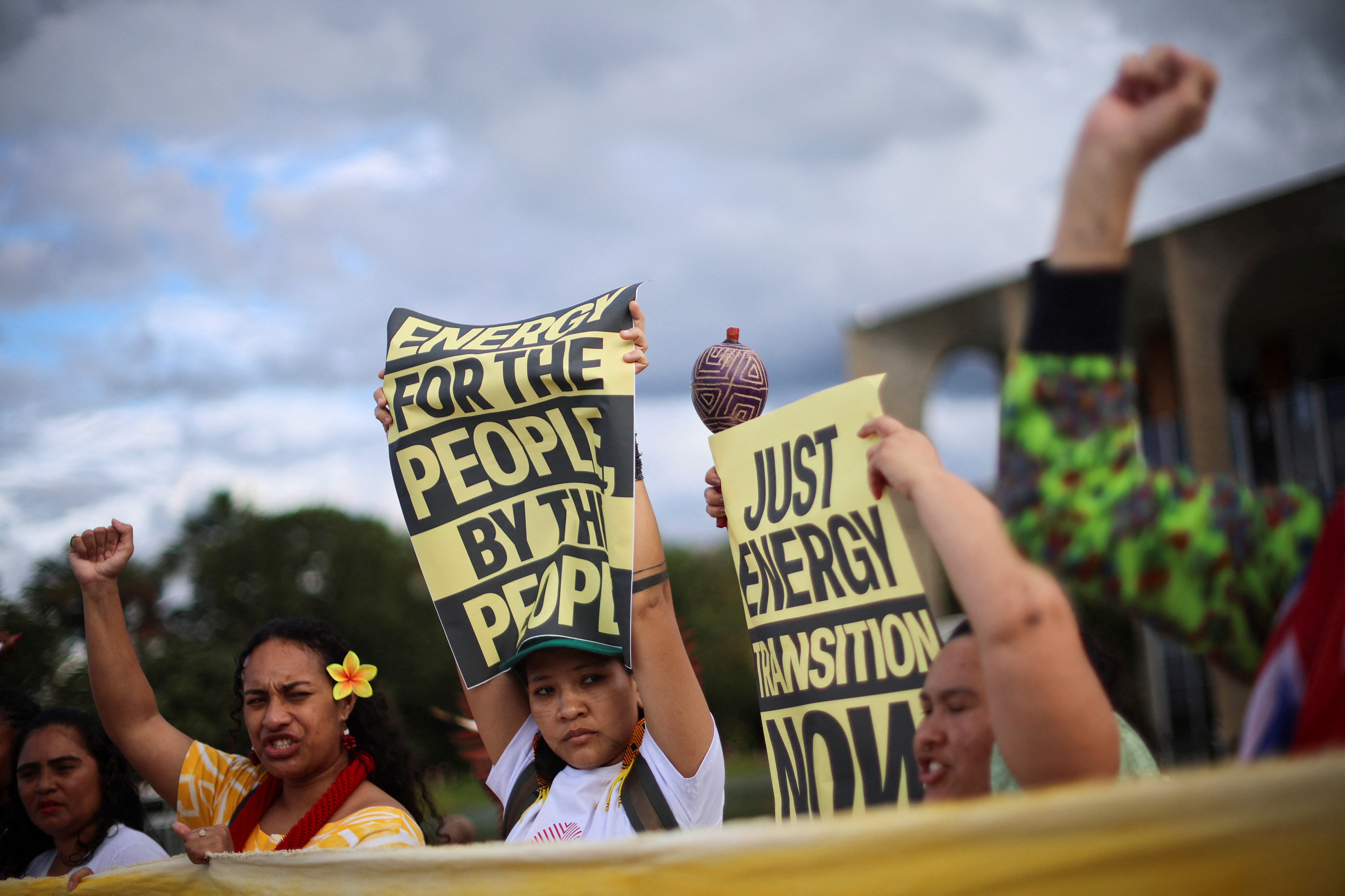 Activists hold signs during a performance and protest by Brazilian artist and activist Mundano, which asks for a response to the letter sent by the Terra Livre (Free Land) Indigenous movement to the presidency of COP30, in front of Itamaraty in Brasilia, Brazil April 15, 2025. REUTERS/Adriano Machado