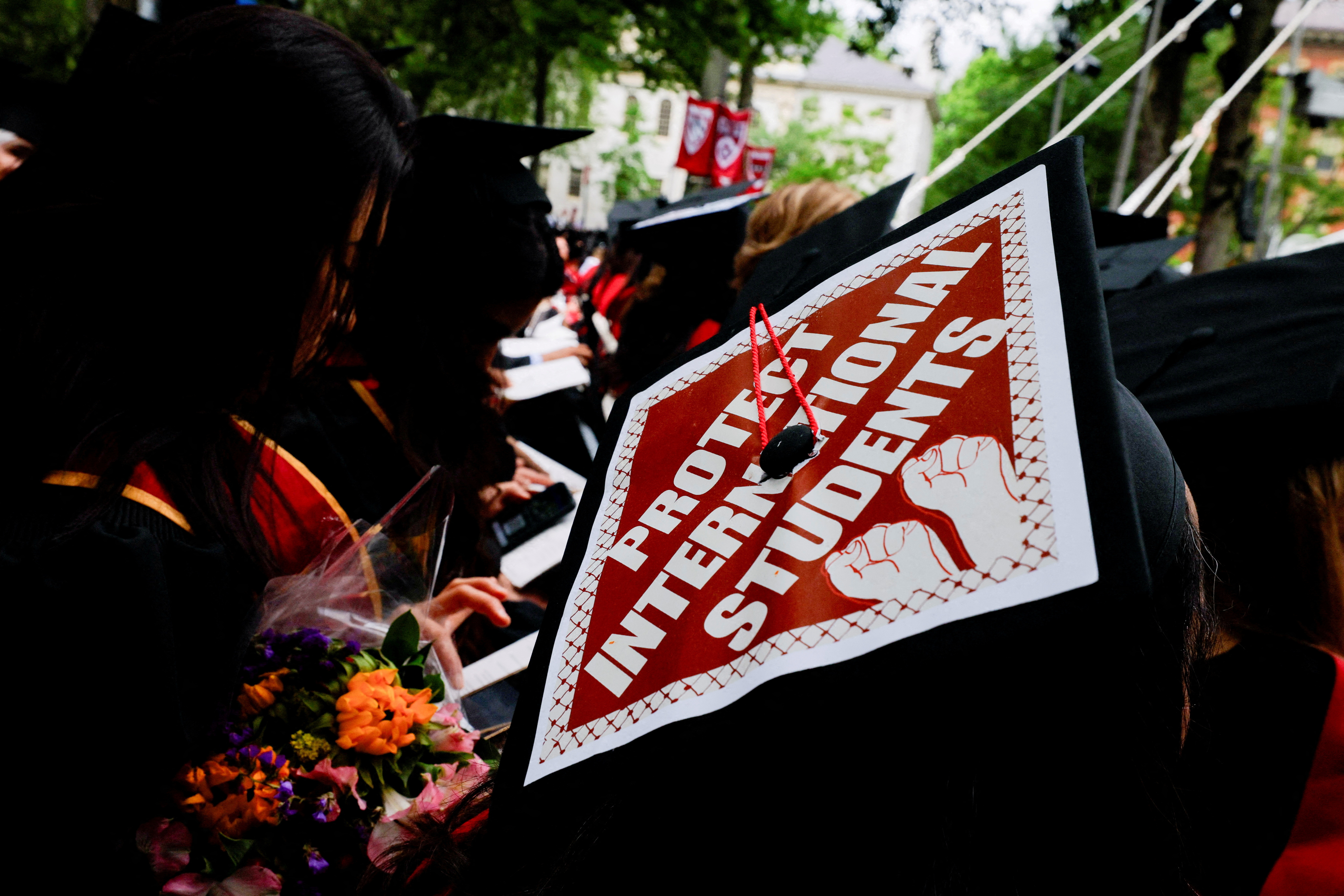 A graduating student wears their hat decorated with a statement of support for international students at Harvard University in Cambridge, Massachusetts, U.S., May 29, 2025. REUTERS/Brian Snyder