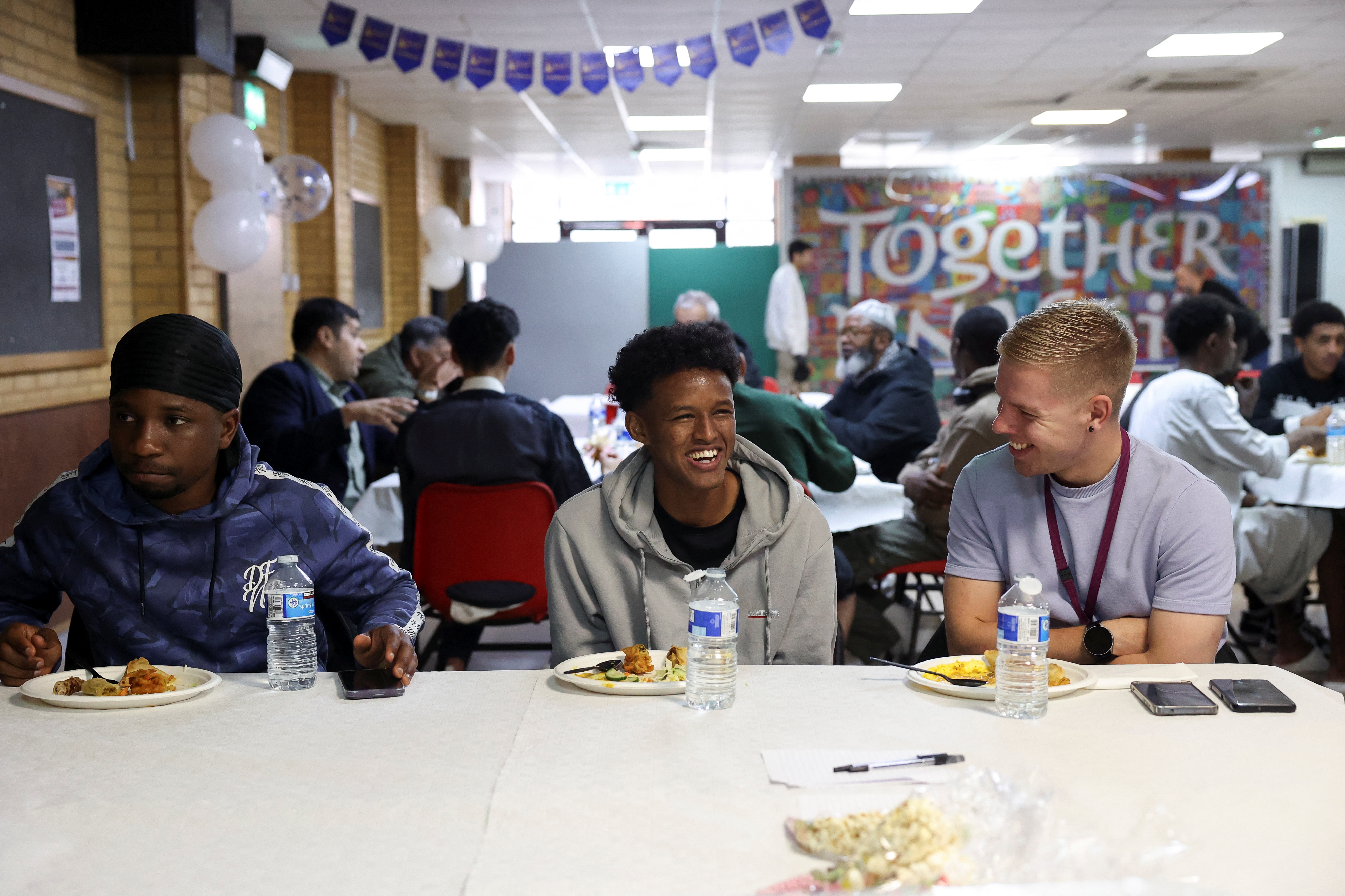 Refugees attend a lunch hosted by Khizra Mosque in Manchester as part of its Eid al-Adha celebrations, in Manchester, Britain, June 7, 2025. REUTERS/Temilade Adelaja