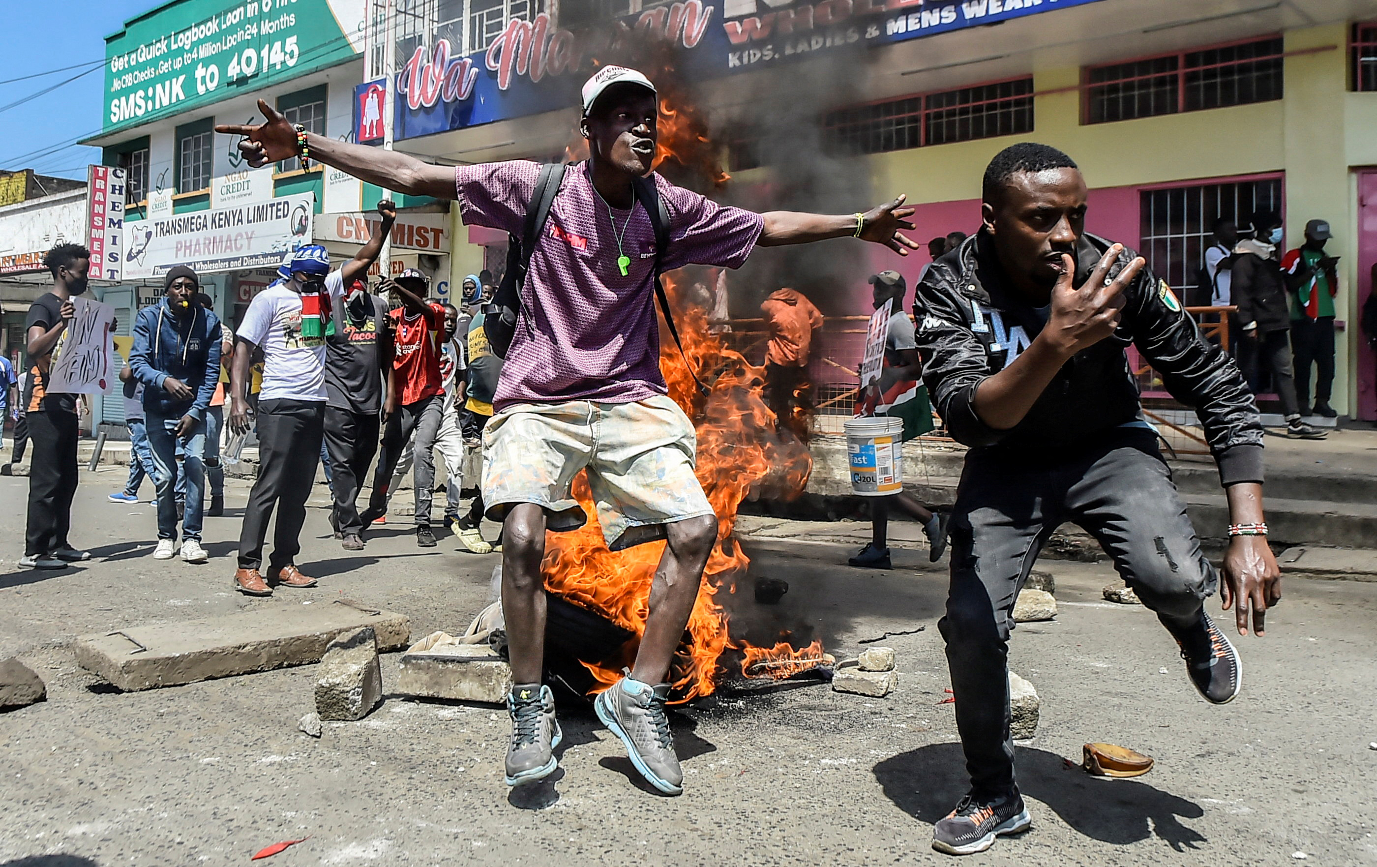 Protesters react next to burning tyres during demonstrations to mark the first anniversary of the deadly 2024 anti-government protests that drew widespread condemnation over the use of force by security agencies, in Nakuru, Kenya June 25, 2025. REUTERS/Suleiman Mbatiah