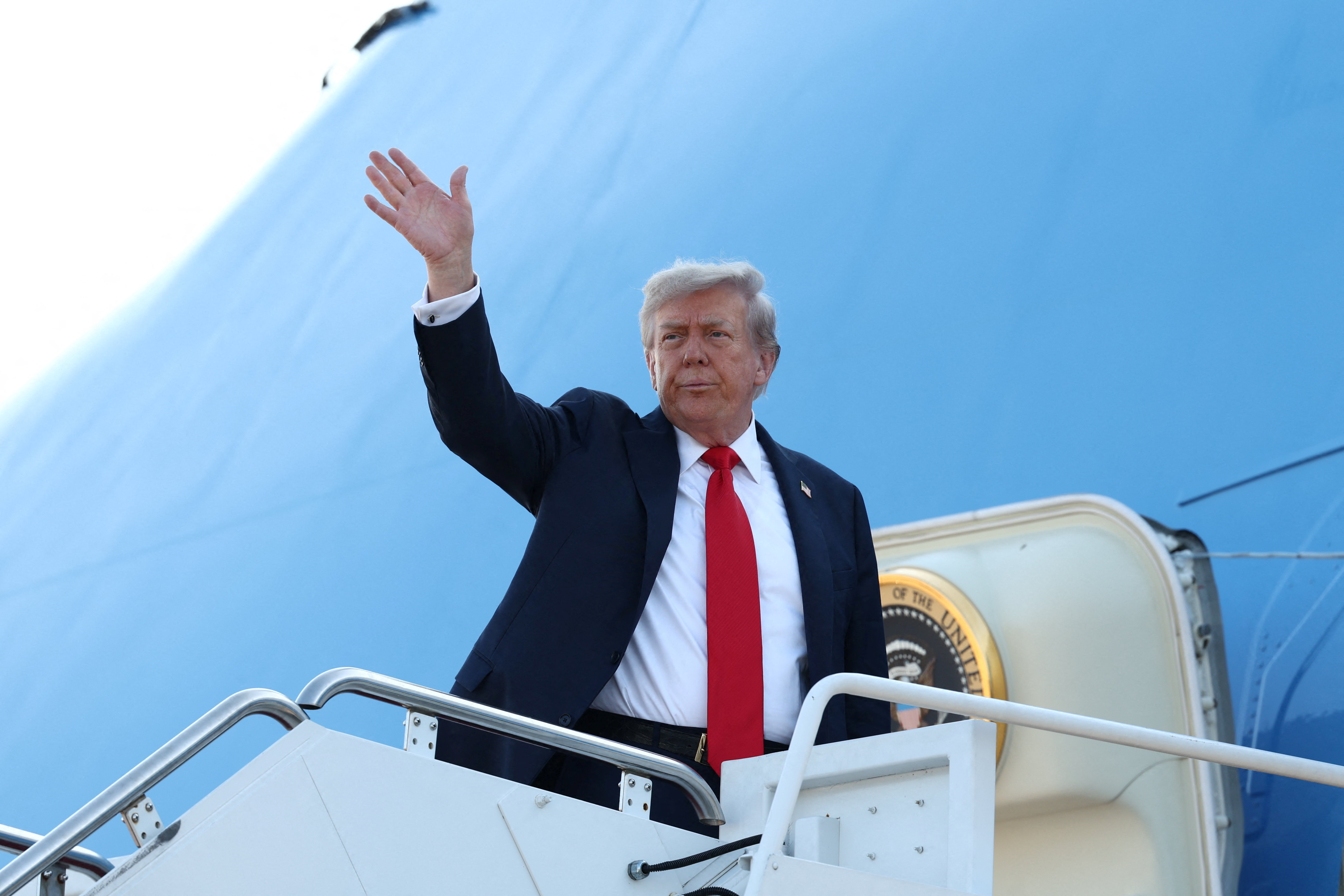 U.S. President Donald Trump boards Air Force One as he departs for Alaska to meet with Russian President Vladimir Putin to negotiate for an end to the war in Ukraine, from Joint Base Andrews in Maryland, U.S., August 15, 2025. REUTERS/Kevin Lamarque