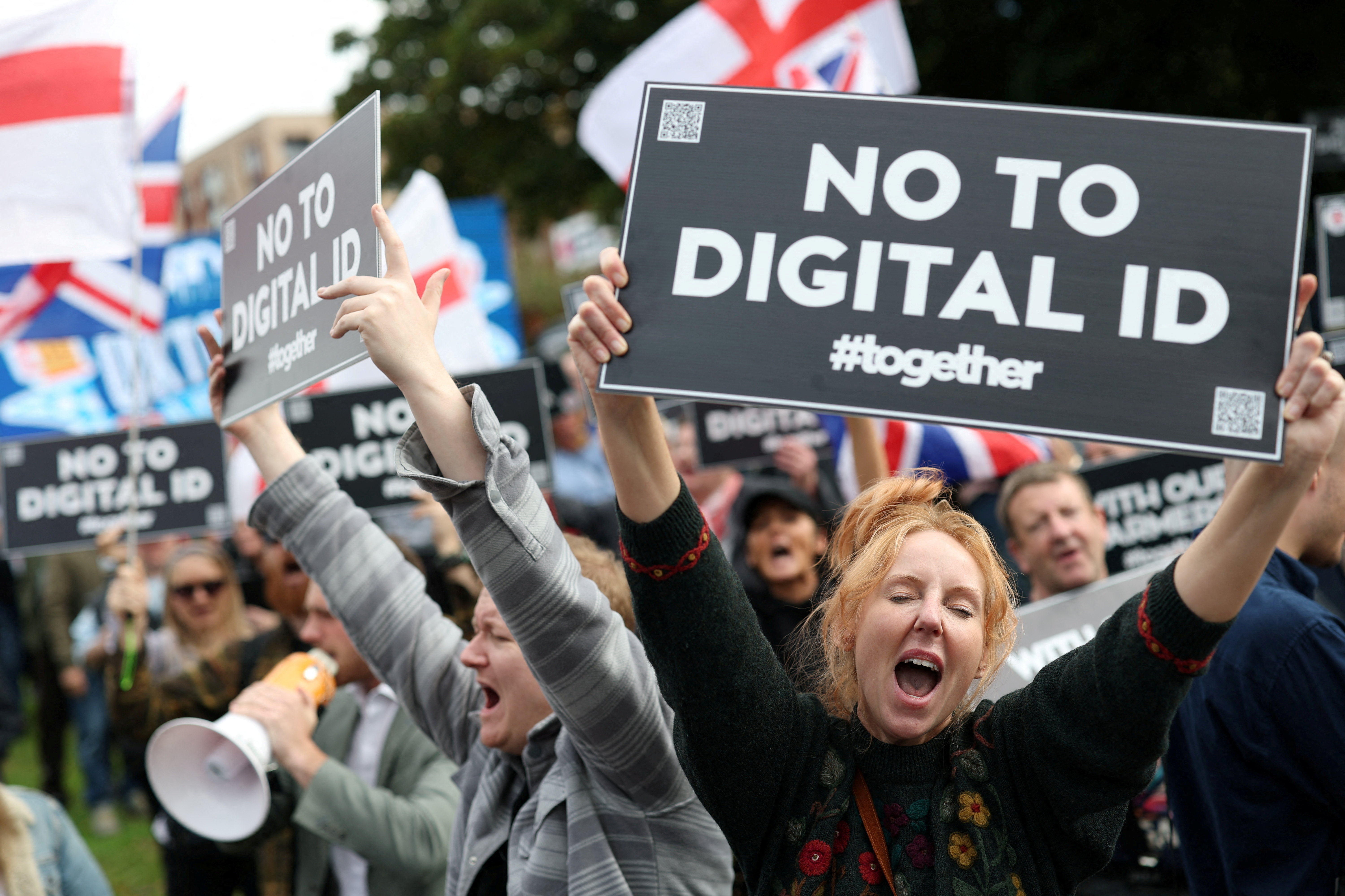 Protesters hold signs during a 'No to Digital ID' demonstration near to the Labour Party Conference in Liverpool, Britain, September 28, 2025. REUTERS/Hannah McKay