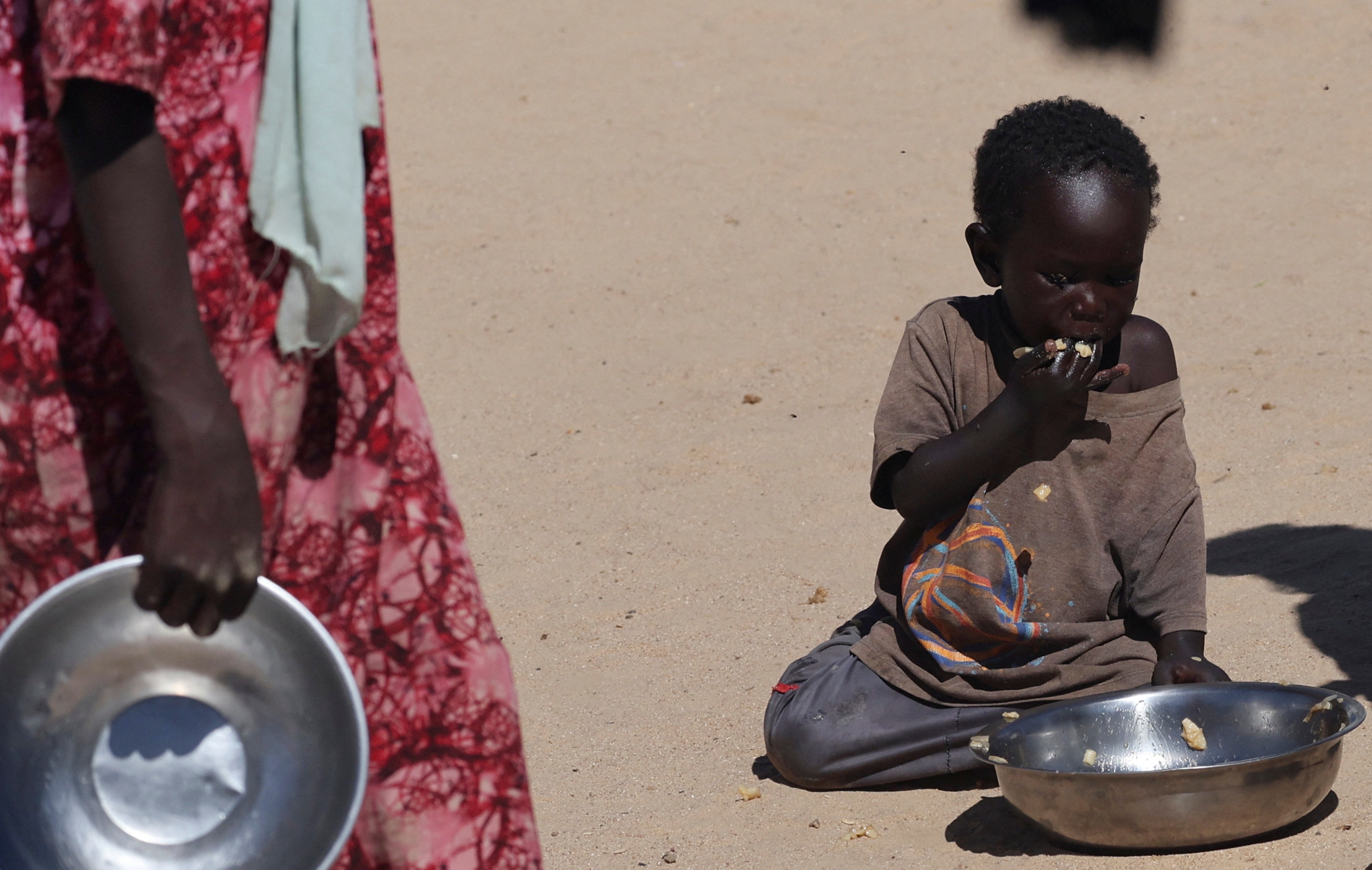 A Sudanese orphaned child refugee from al-Fashir eats inside the Tine transit camp in eastern Chad, November 22, 2025. REUTERS/Amr Abdallah Dalsh