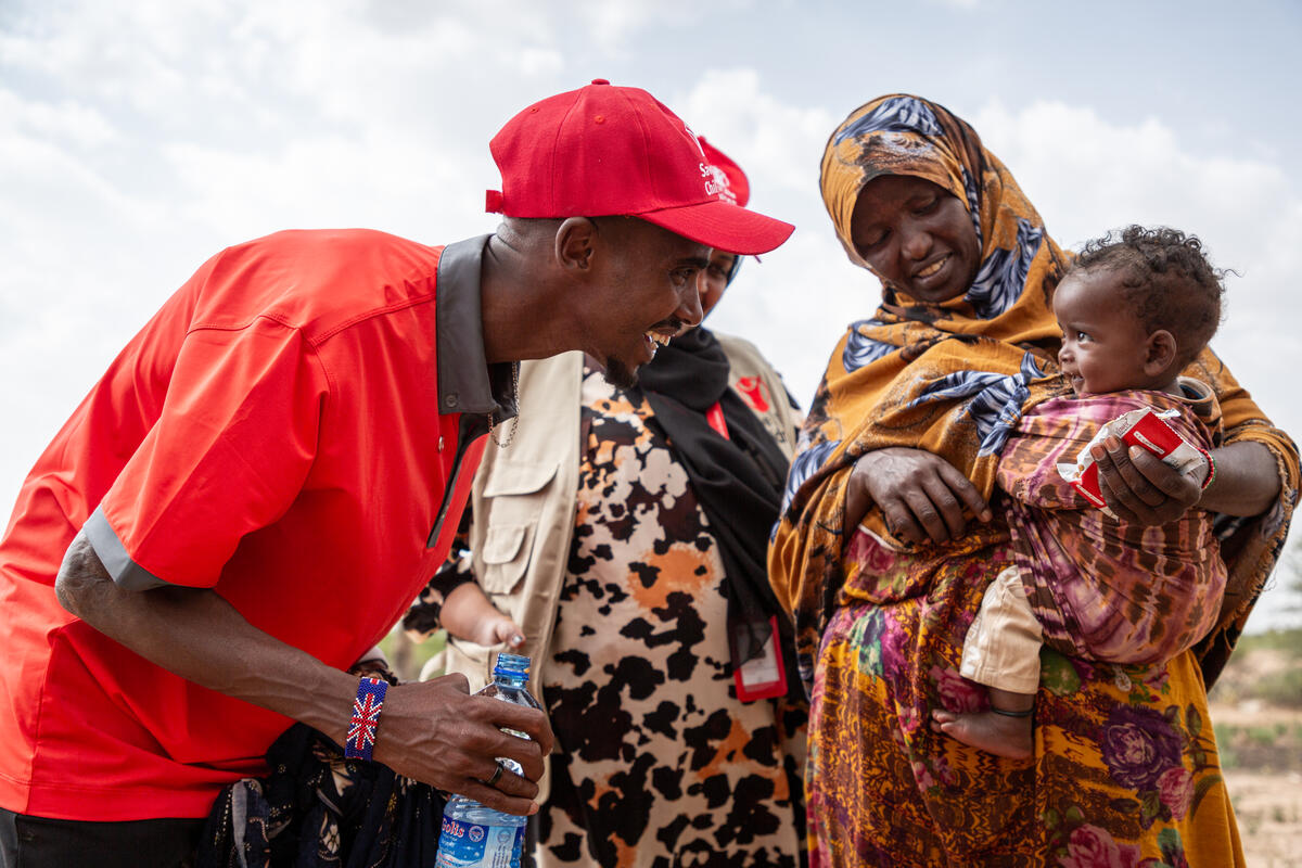 Save the Children Ambassador, Sir Mo Farah, meets a woman and her malnourished child in Somaliland, May 28, 2024. Mustafa Saeed/Save the Children/Handout via Thomson Reuters Foundation
