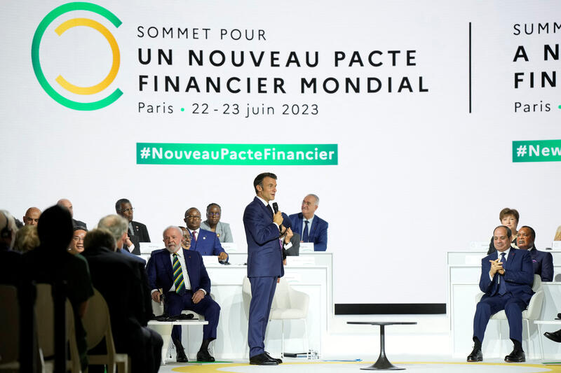 French President Emmanuel Macron, center, speaks while Brazilian President Luiz Inacio Lula Da Silva, left, and Egyptian President Abdel Fattah el-Sisi, right, listen during the closing session of the New Global Financial Pact Summit, Friday, June 23, 2023 in Paris, France. Lewis Joly/Pool via REUTERS