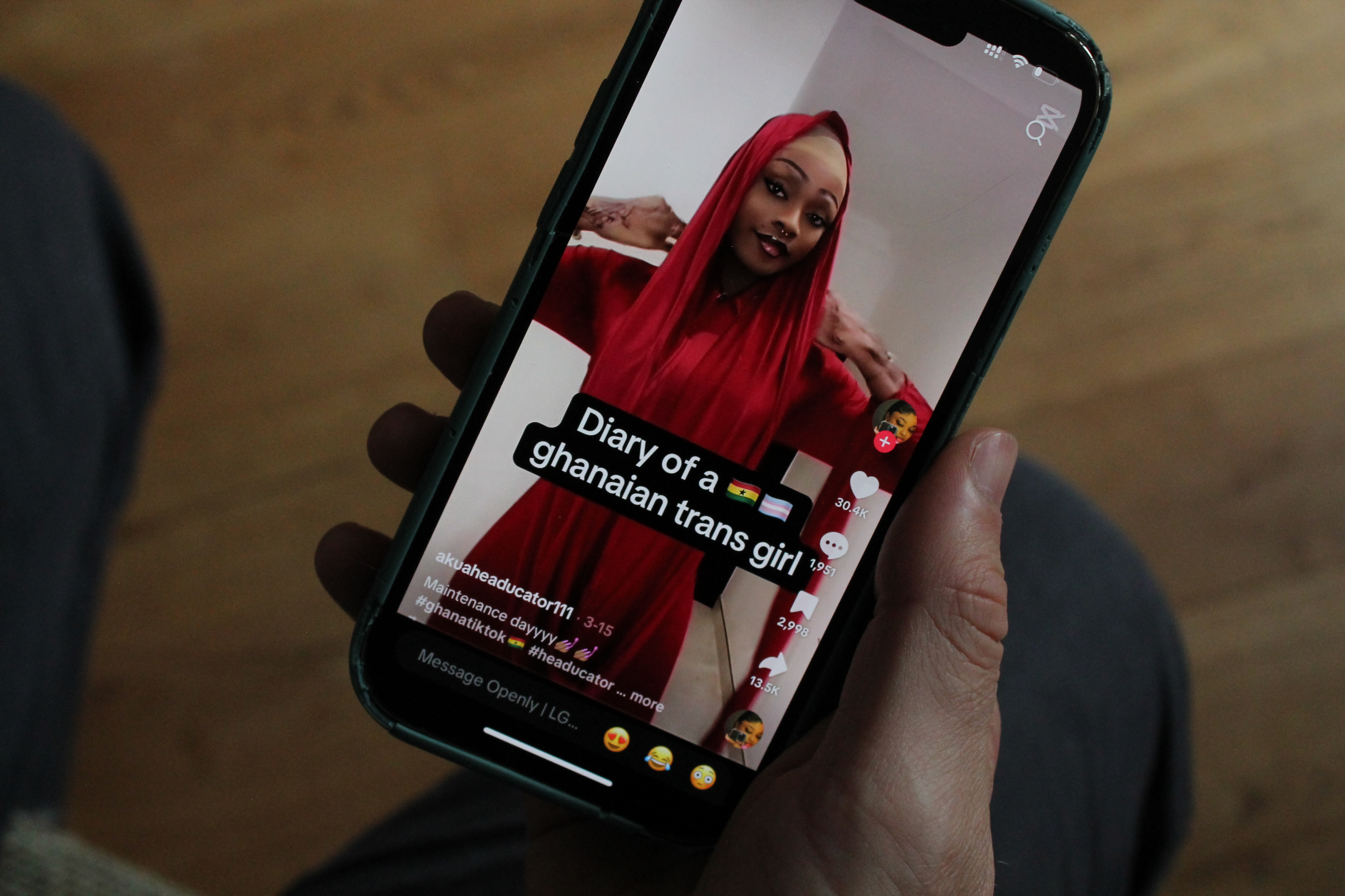 A TikTok user watches a video of Giselle, 21, an openly trans woman and content creator in Ghana. Thomson Reuters Foundation/Enrique Anarte