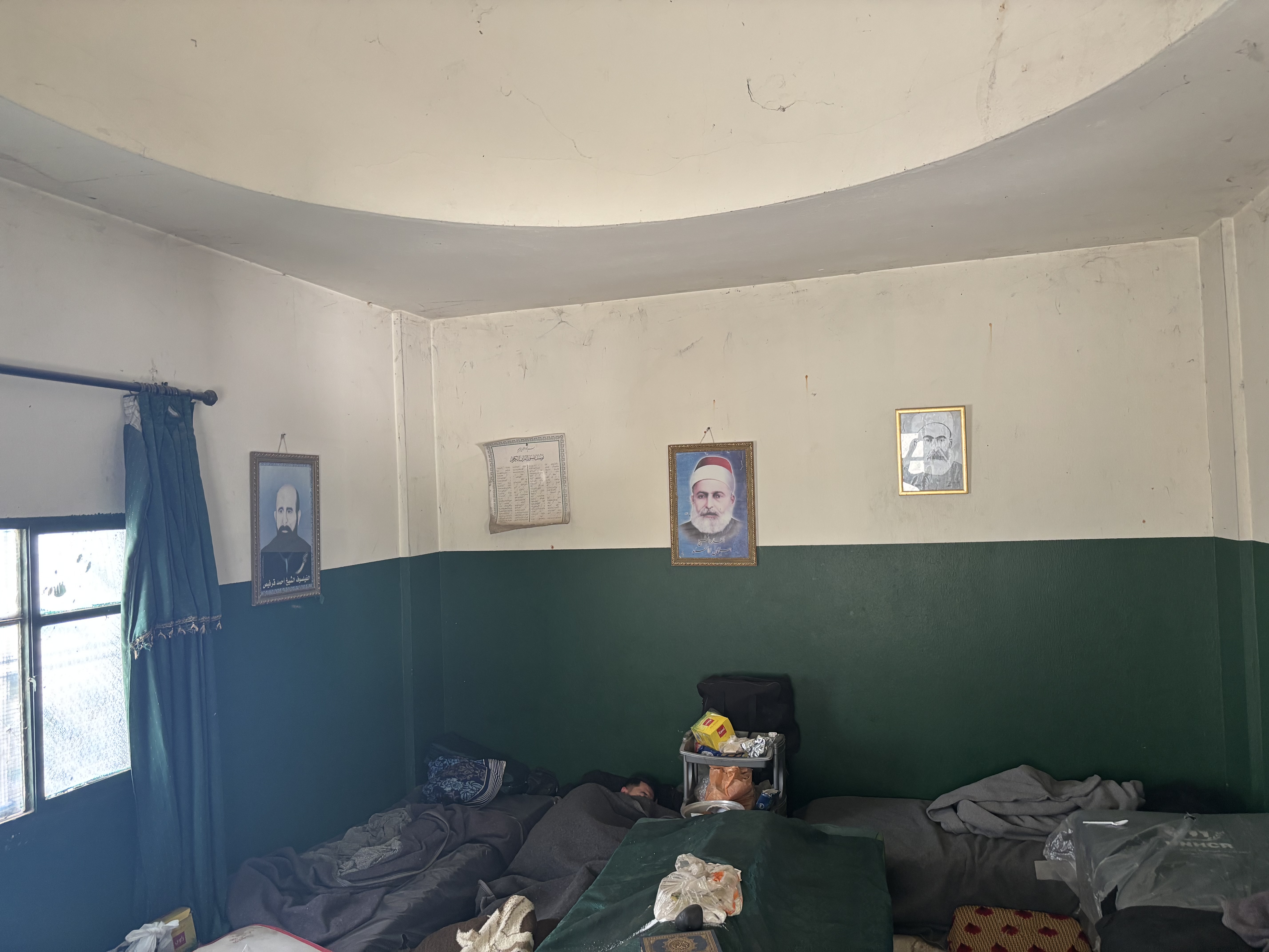 People sleep by the shrine of a saint at the mosque in Hissa, Lebanon. May 9, 2025. Thomson Reuters Foundation/Nazih Osseiran