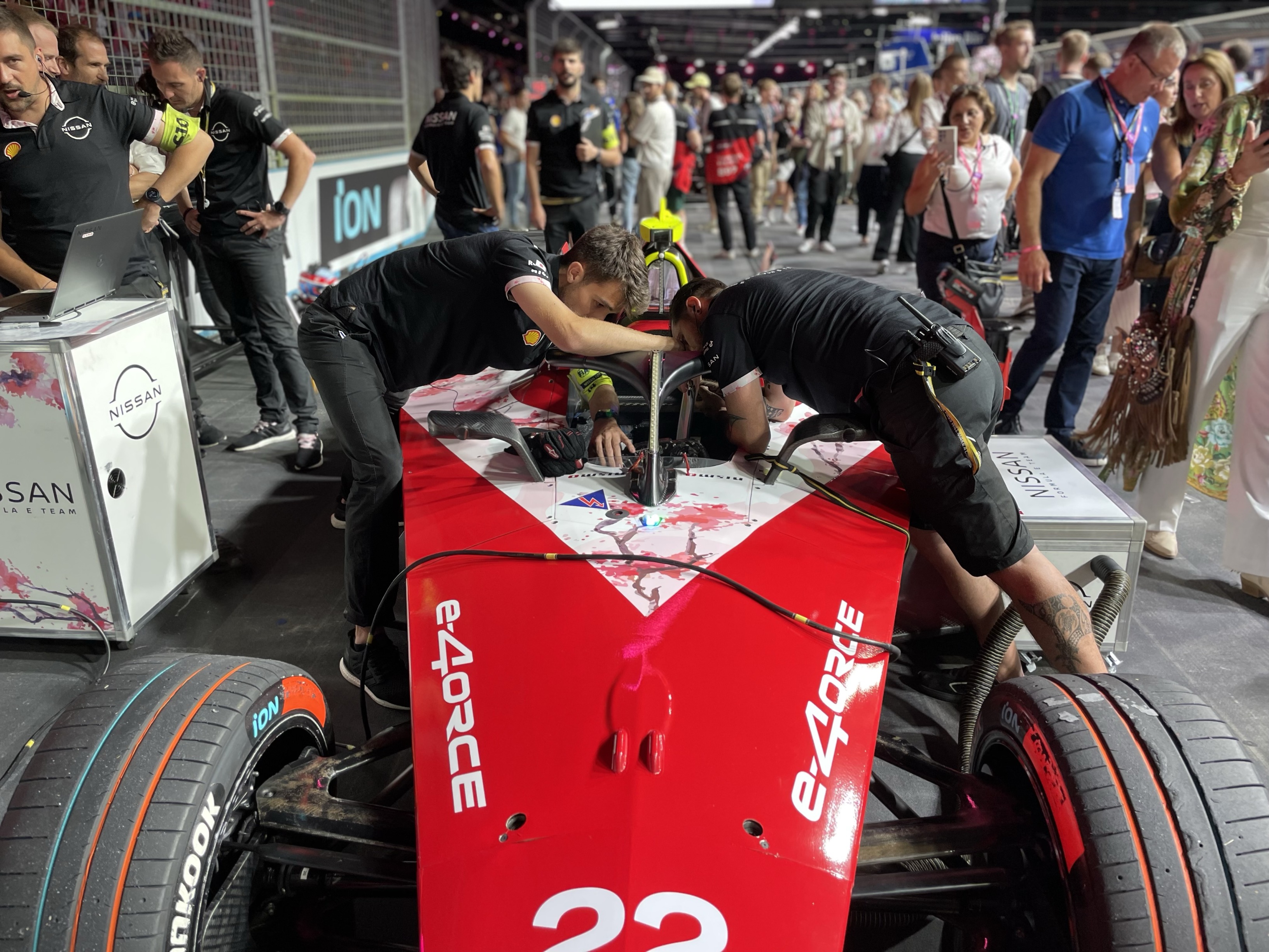 Members of the Nissan Formula E team make final adjustments to the Nissan e-4ORCE 04 race car before round 15 of the Formula E world championship at the ExCeL Centre in London, July 20, 2024.