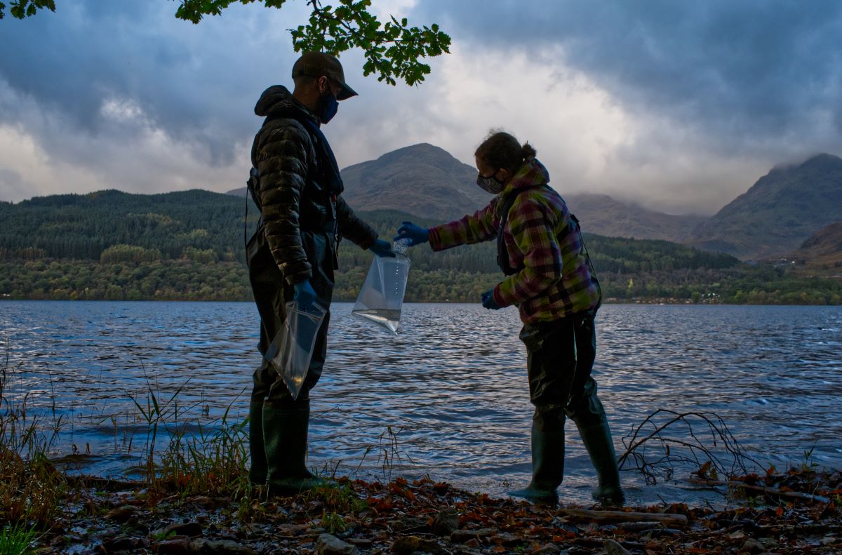 Scientists from monitoring company NatureMetrics collect water to then capture traces of DNA to identify local wildlife species, in The Trossachs National Park, Scotland, October 20, 2021