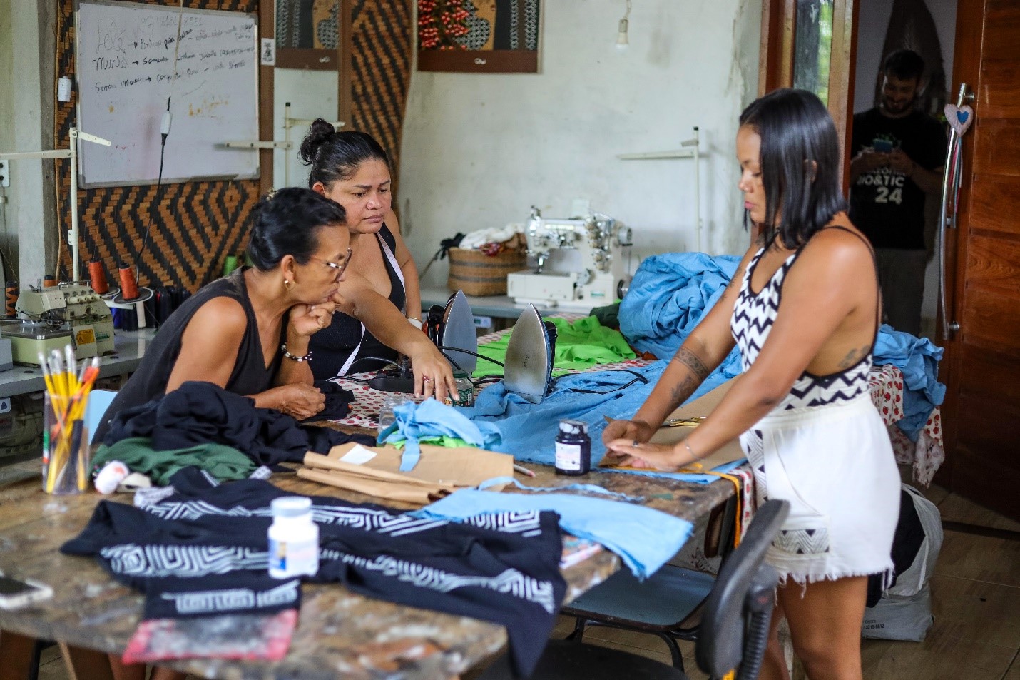 Leia Witoto, Gleice Mura and Lecia Witoto make clothes in Ateliê Derequine’s headquarters in Manaus, Brazil, March 12, 2025. Nathalie Brasil/Thomson Reuters Foundation