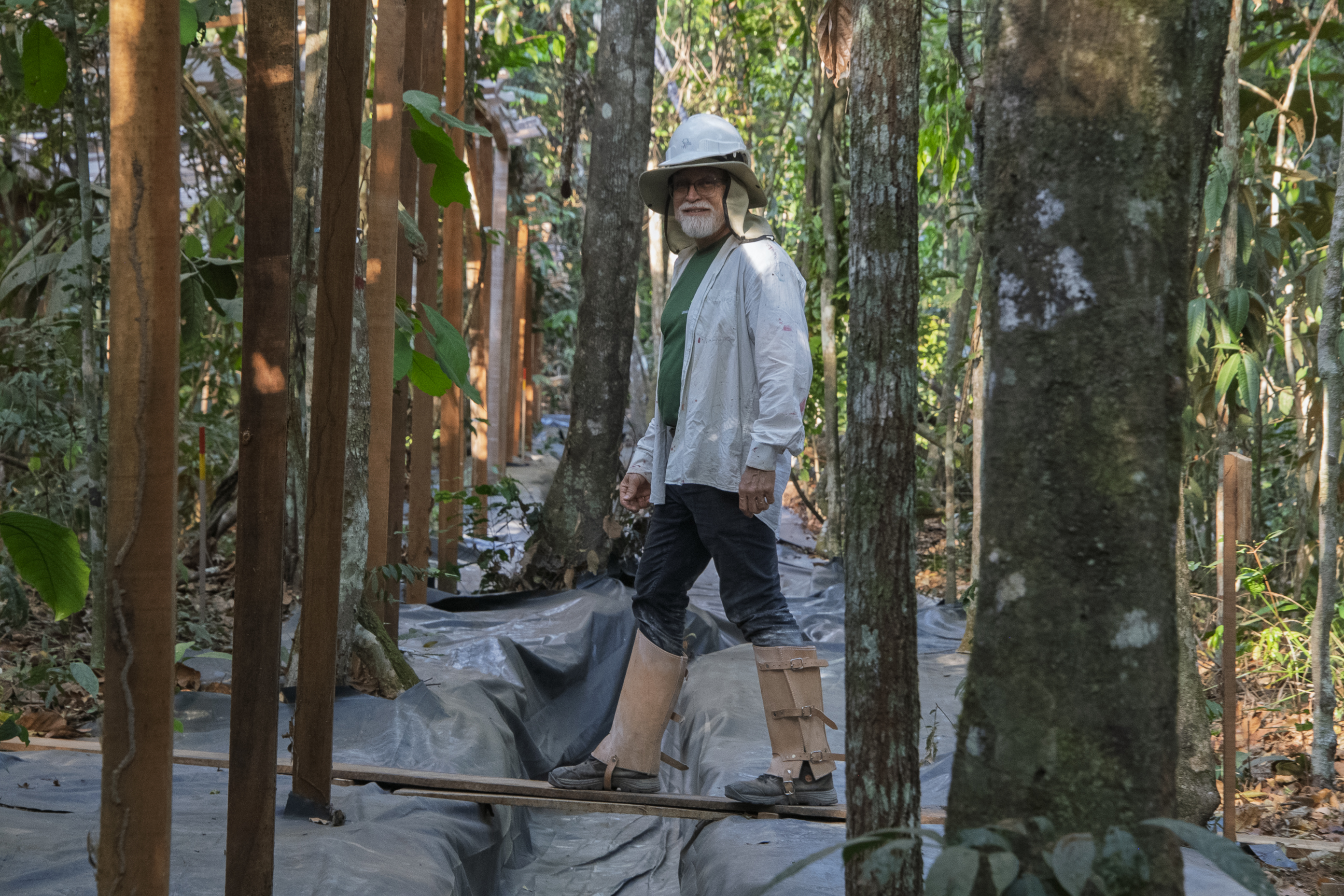 Researcher Ben Hur Marimon Jr. walks over a plastic-covered gutter on a patch of Amazon forest in the Limit Drought experiment, in Querência, Brazil, August 25, 2025. Thomson Reuters Foundation/Rogério Florentino